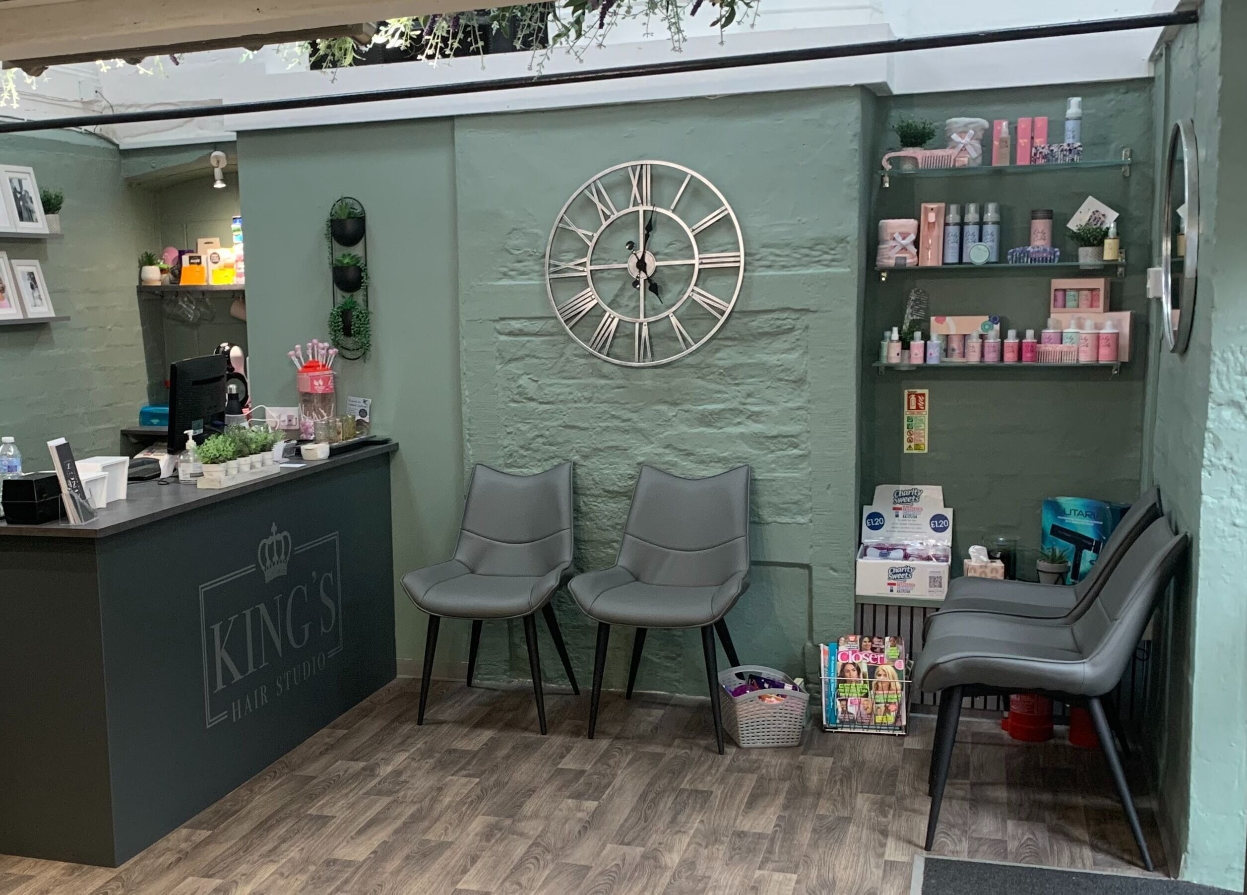Reception area of King's Hair Studio in Carlisle, England, GB with chic decor and modern furnishings.