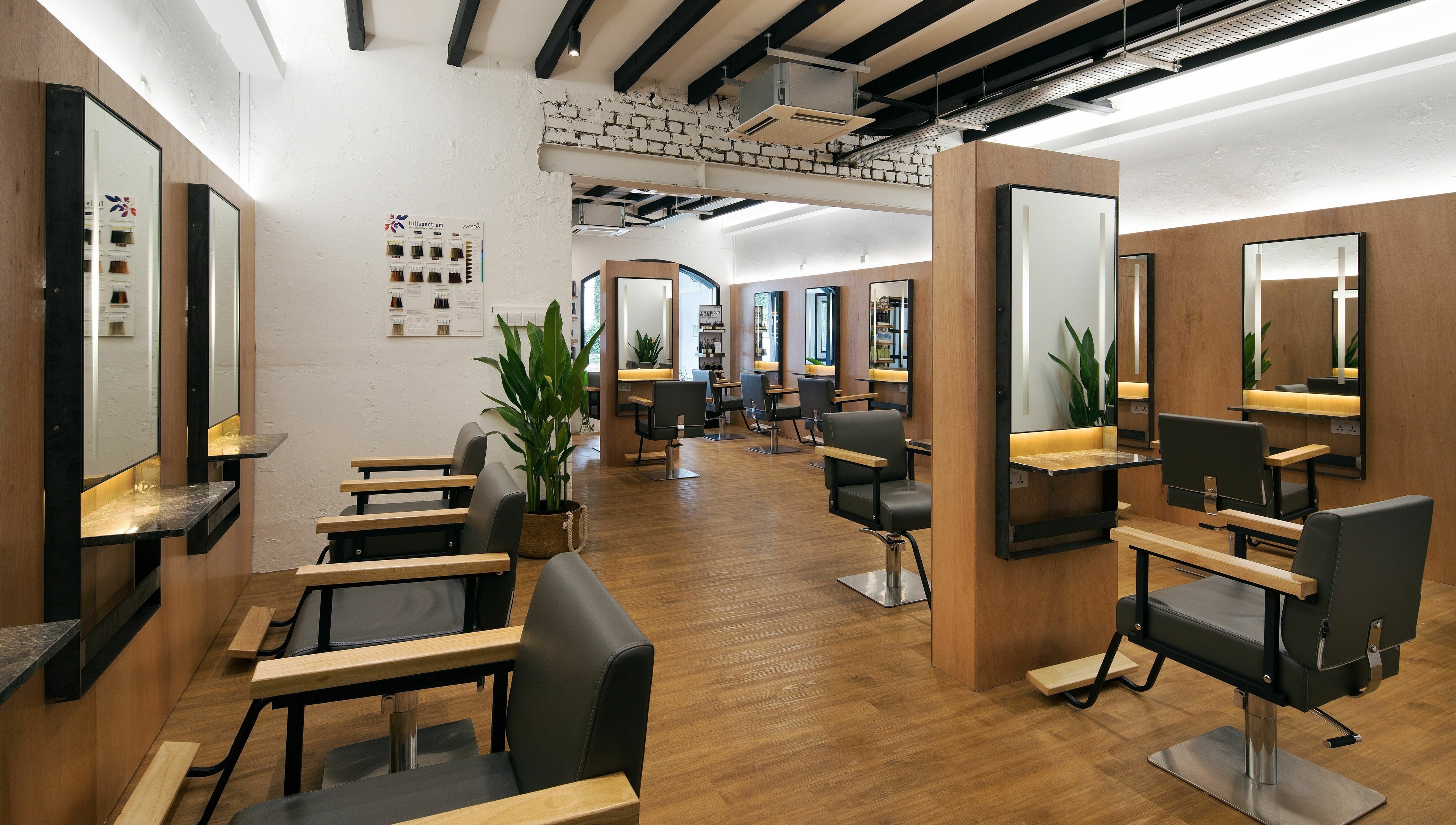 Modern interior of Trimmings Salon and Spa on Orchard Road, Singapore. Stylish chairs and mirrors decorate the space.