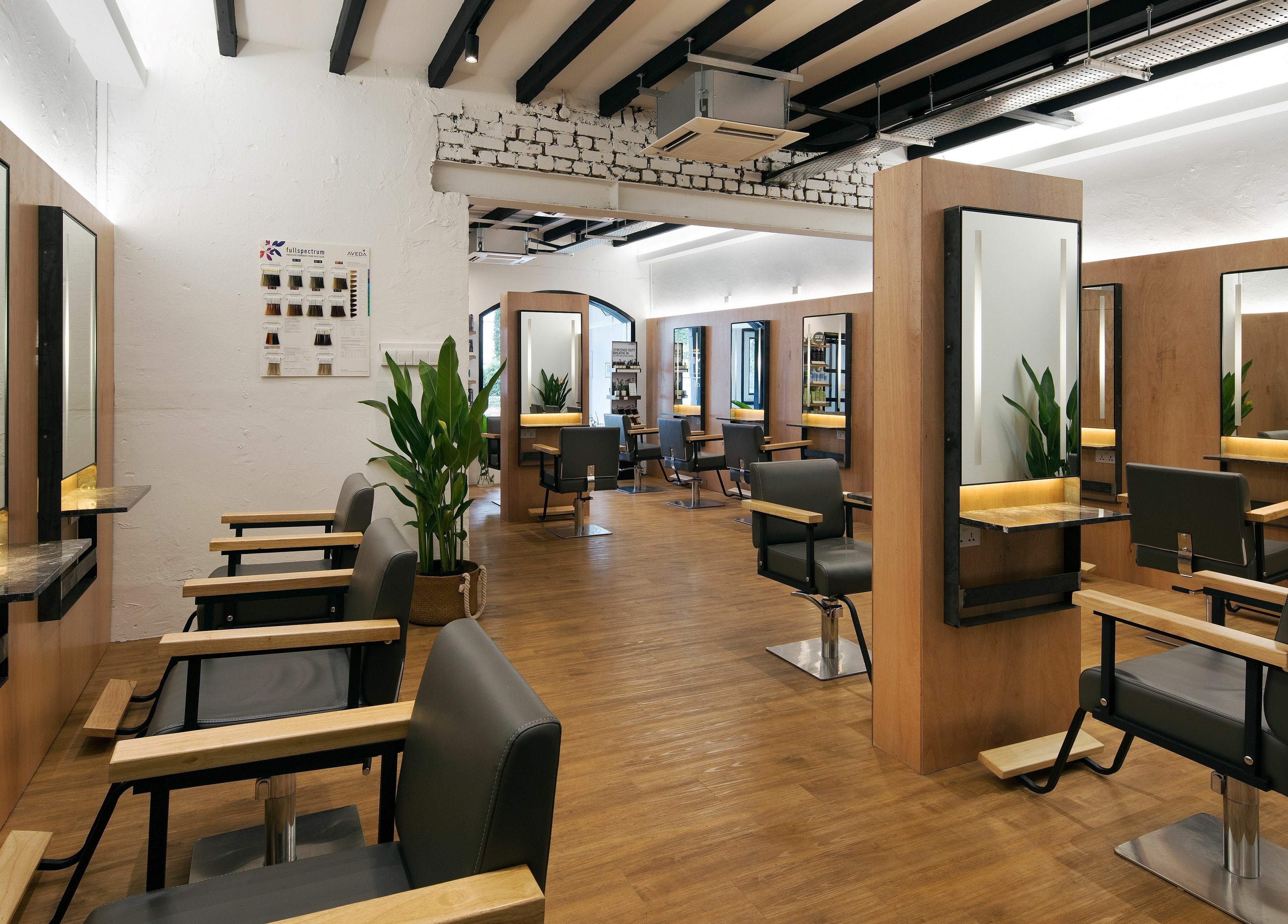 Modern interior of Trimmings Salon and Spa on Orchard Road, Singapore. Stylish chairs and mirrors decorate the space.