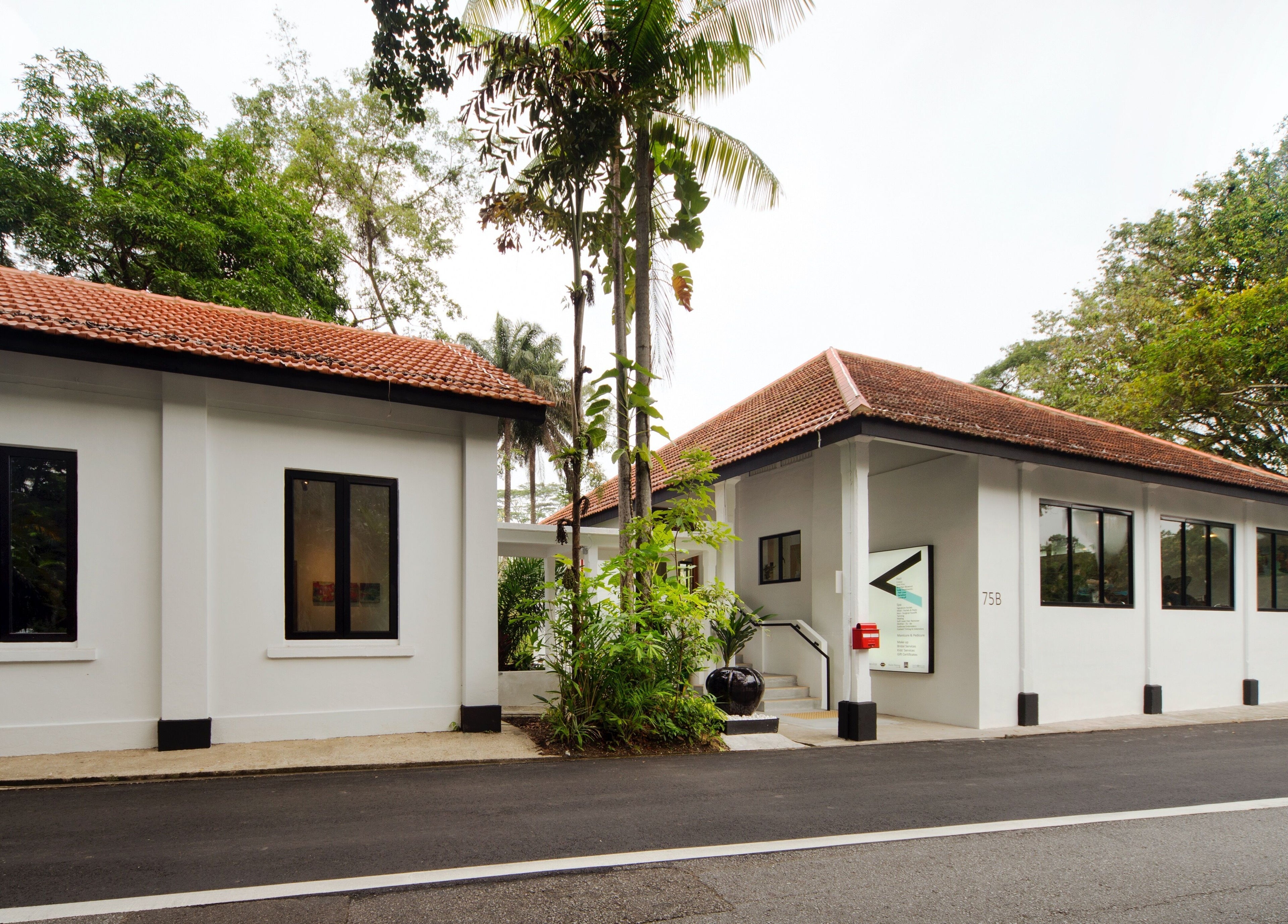 Exterior of Trimmings Salon & Spa | Dempsey Hill in Singapore, Singapore, SG, surrounded by lush greenery.