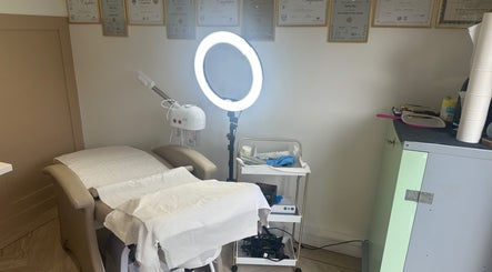 Cozy salon treatment area at Platinum Hair & Beauty in Southampton, England, GB with massage bed and ring light.