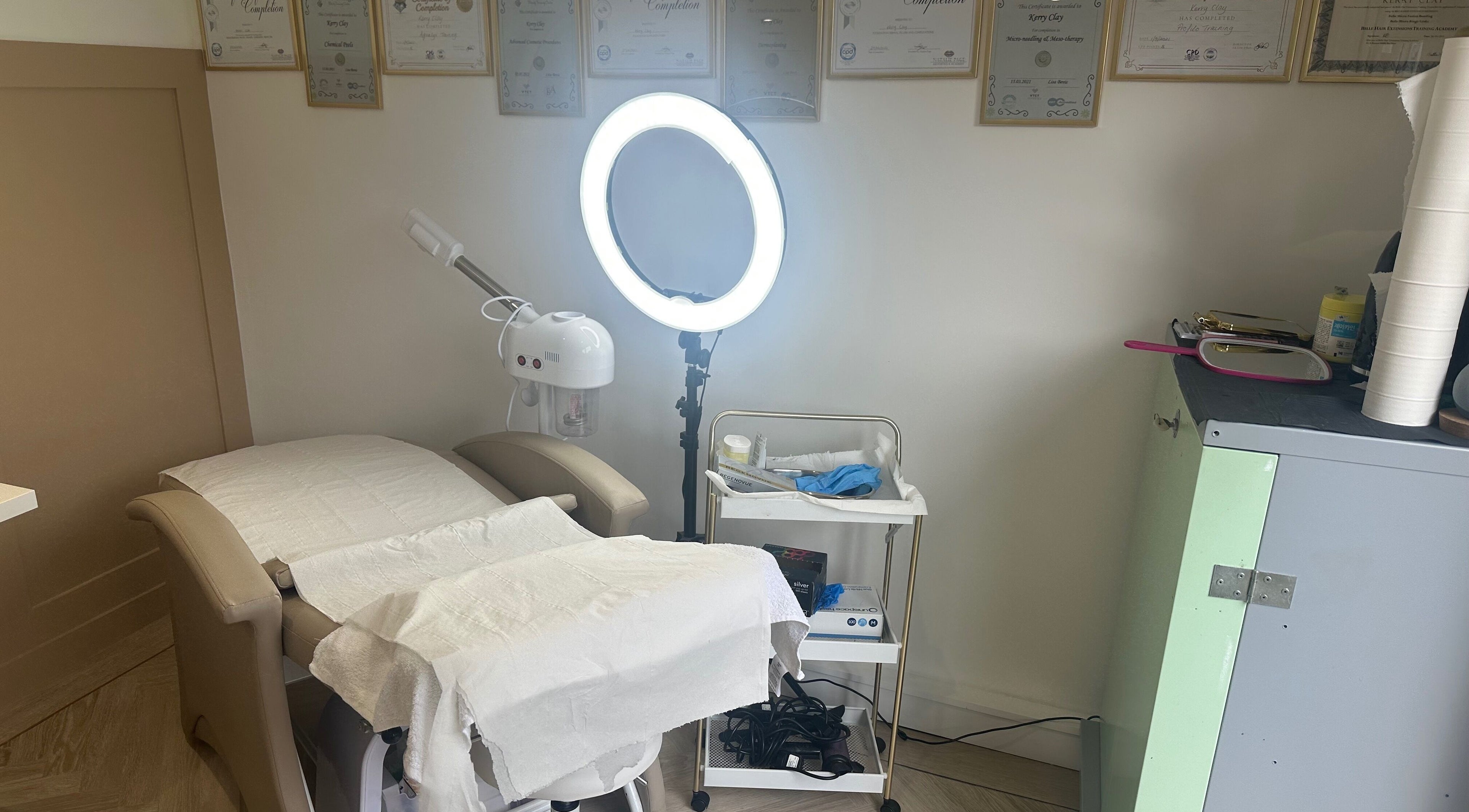 Cozy salon treatment area at Platinum Hair & Beauty in Southampton, England, GB with massage bed and ring light.