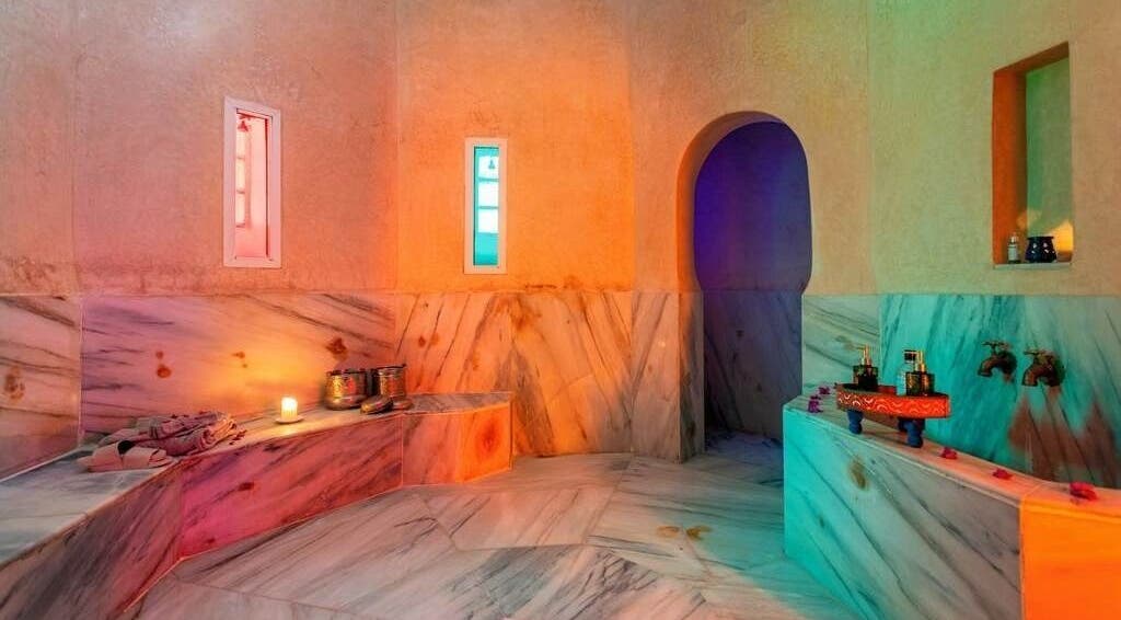 Relaxing Moroccan hammam at Spa Les Borjs de la Kasbah, Marrakesh, showcasing marble finishes and ambient lighting.