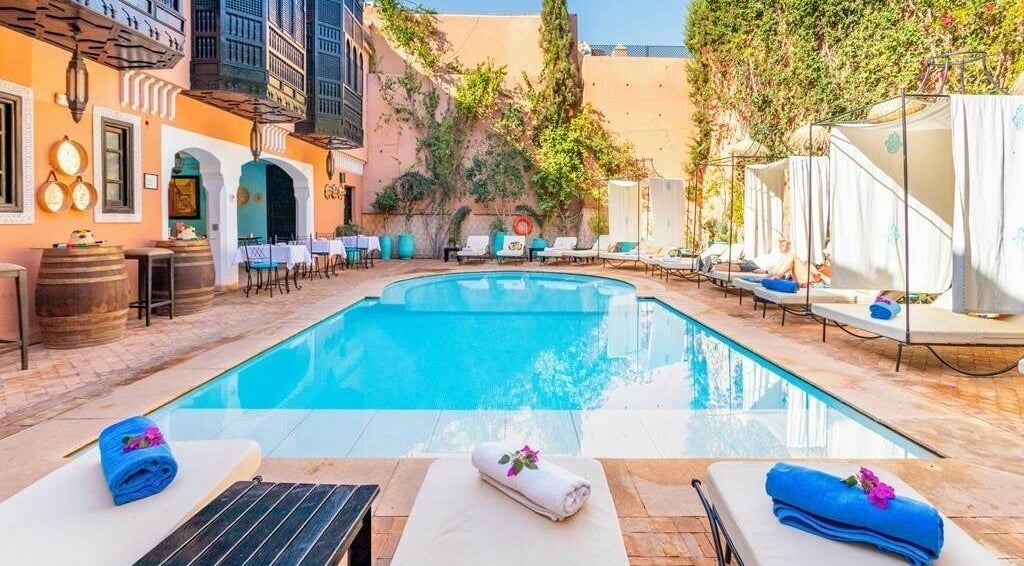 Relaxing poolside at Spa Les Borjs de la Kasbah, Marrakesh, Marrakesh-Safi, MA, with sun loungers and cozy ambiance.