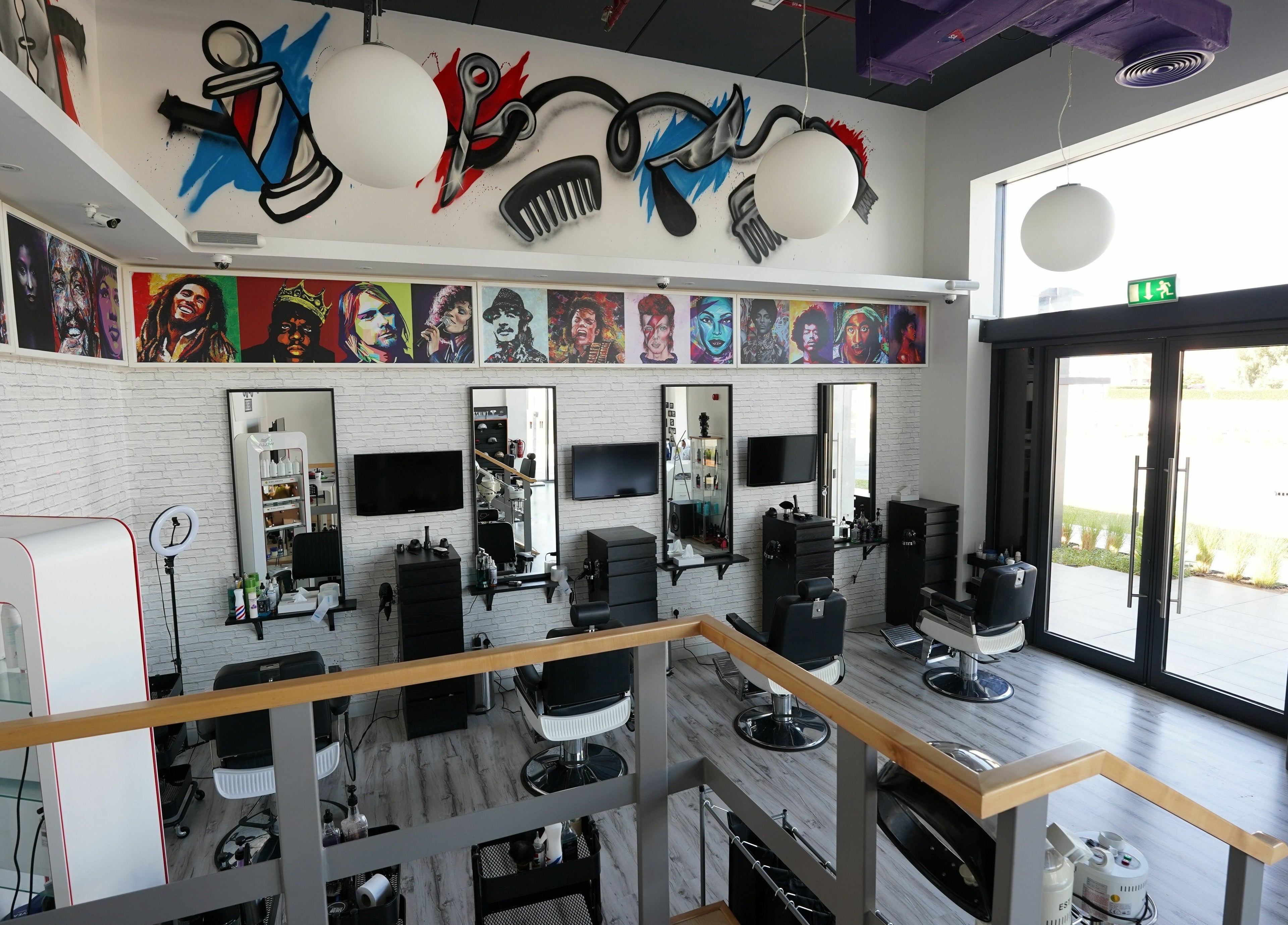Vibrantly decorated interior of Beats and Cuts in Dubai, AE showcasing unique wall art and modern salon setup.