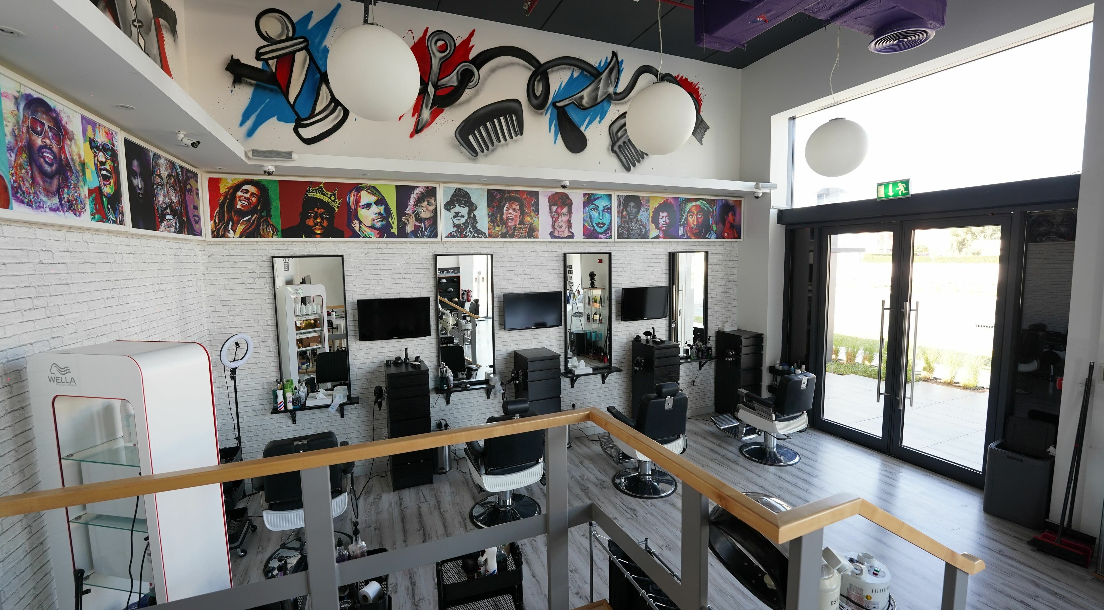 Vibrantly decorated interior of Beats and Cuts in Dubai, AE showcasing unique wall art and modern salon setup.