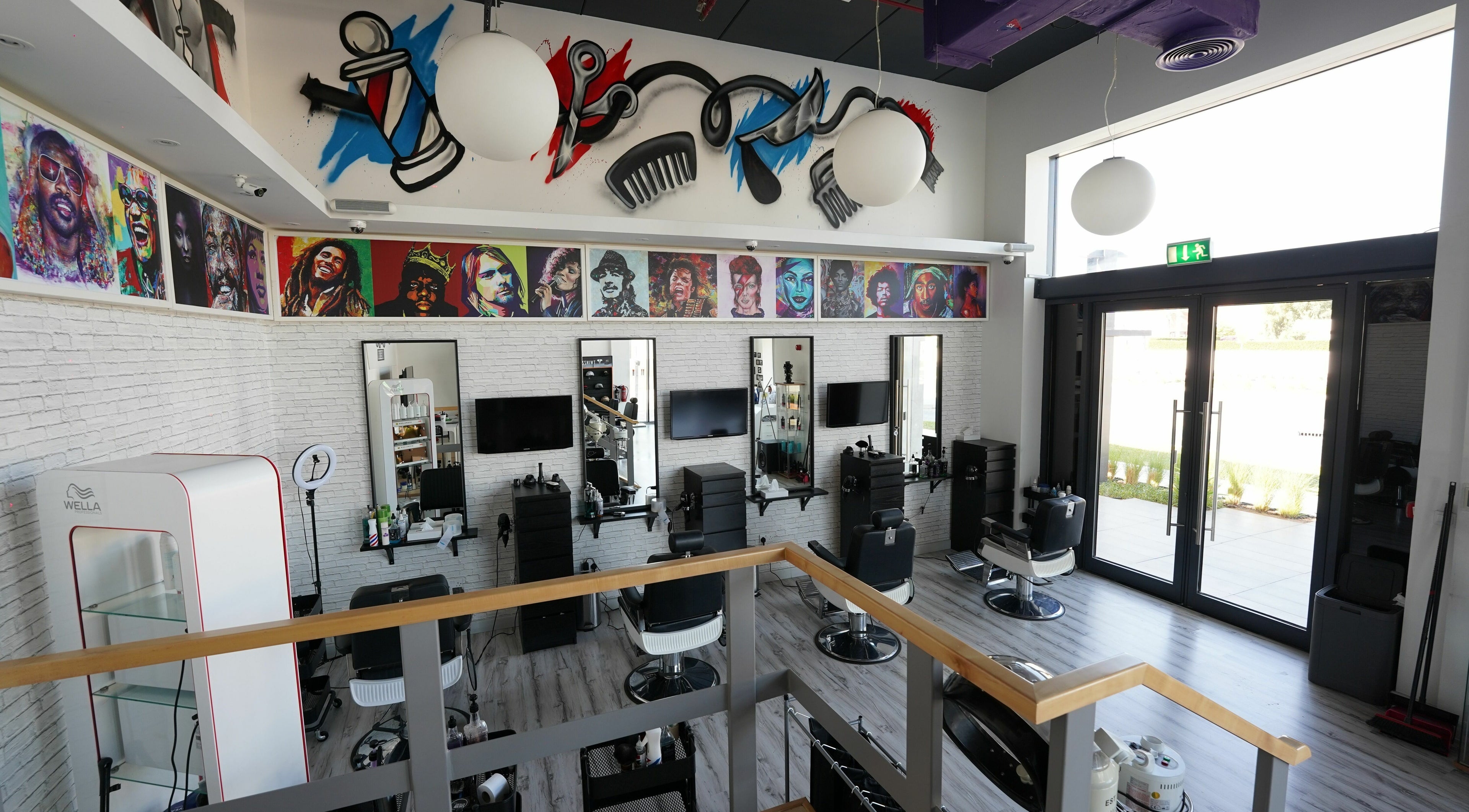Vibrantly decorated interior of Beats and Cuts in Dubai, AE showcasing unique wall art and modern salon setup.