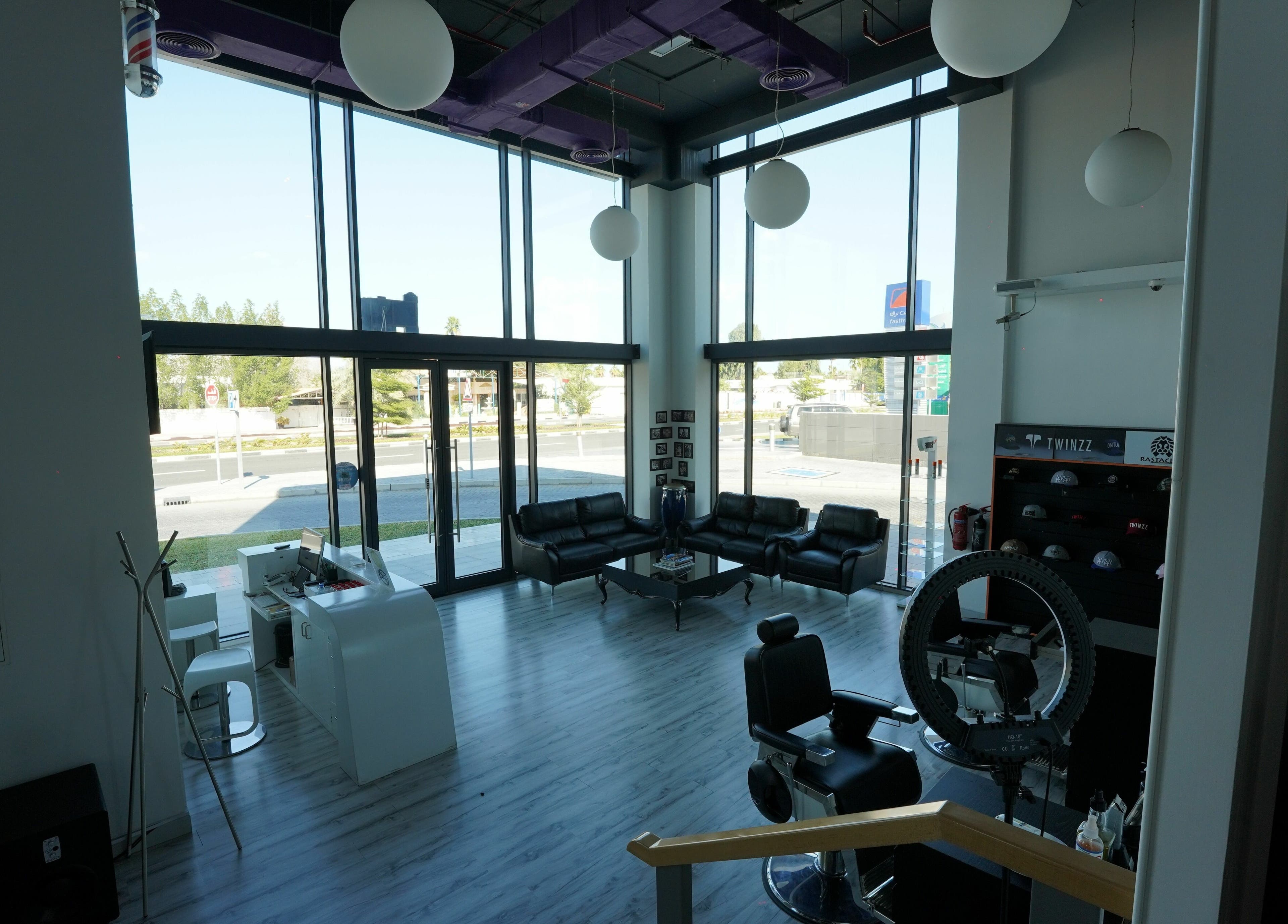 Spacious interior of Beats and Cuts in Dubai, AE, with modern decor and natural light through large windows.