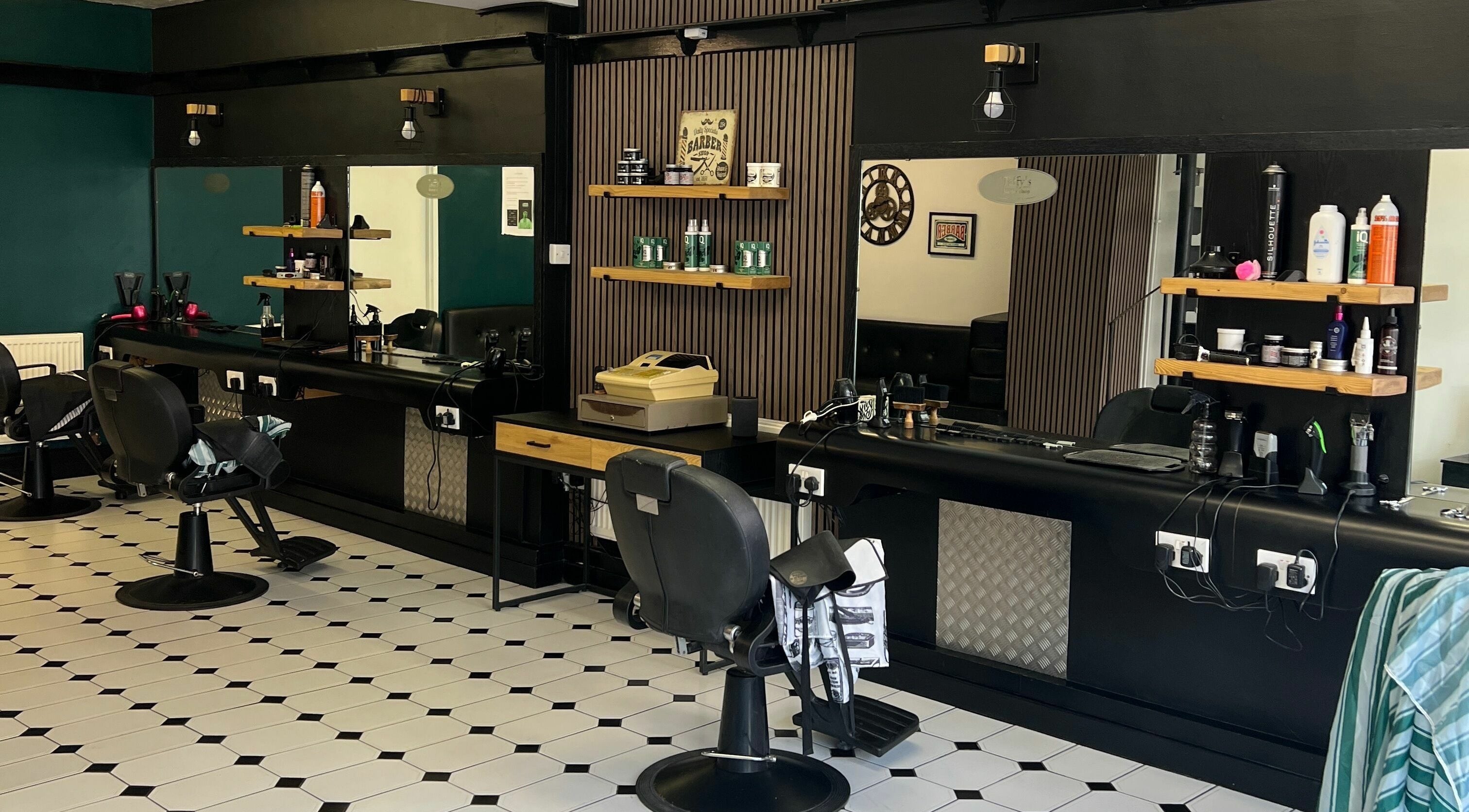 Interior of Taffys’s Barbers Neath, featuring modern chairs and stylish decor, located in Neath, Wales, GB.
