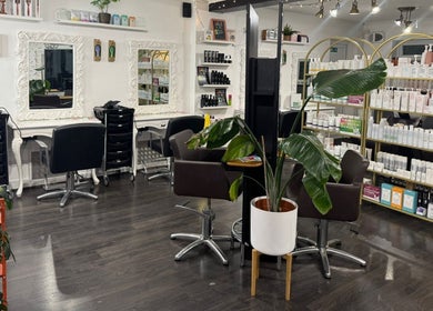 Chic interior of LK Hair and Beauty in Newbury, England, GB, showcasing styling stations and product displays.