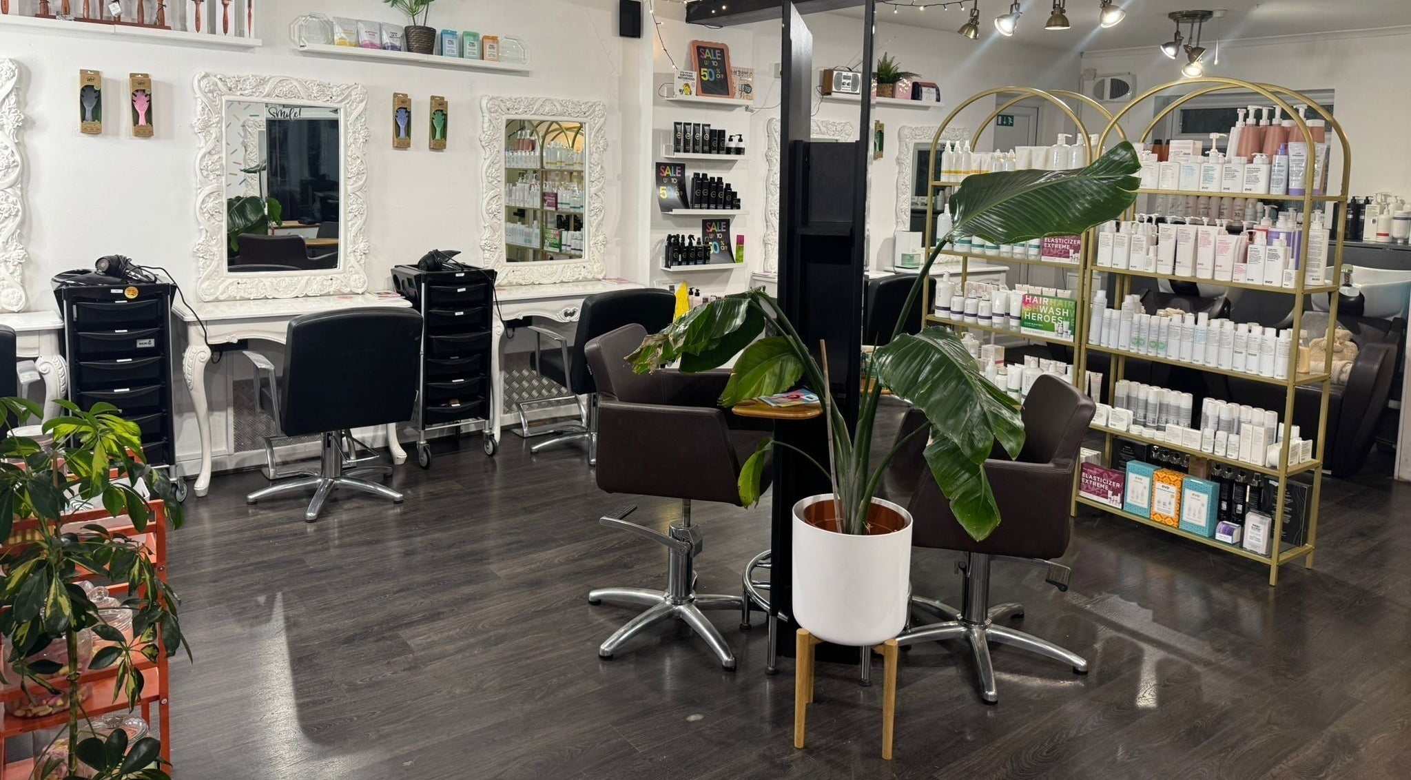 Chic interior of LK Hair and Beauty in Newbury, England, GB, showcasing styling stations and product displays.