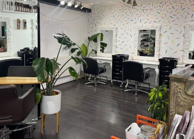 Stylish salon interior at LK Hair and Beauty, Newbury, England, GB, featuring elegant mirrors and cozy seating.