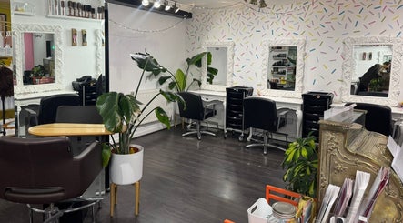 Stylish salon interior at LK Hair and Beauty, Newbury, England, GB, featuring elegant mirrors and cozy seating.
