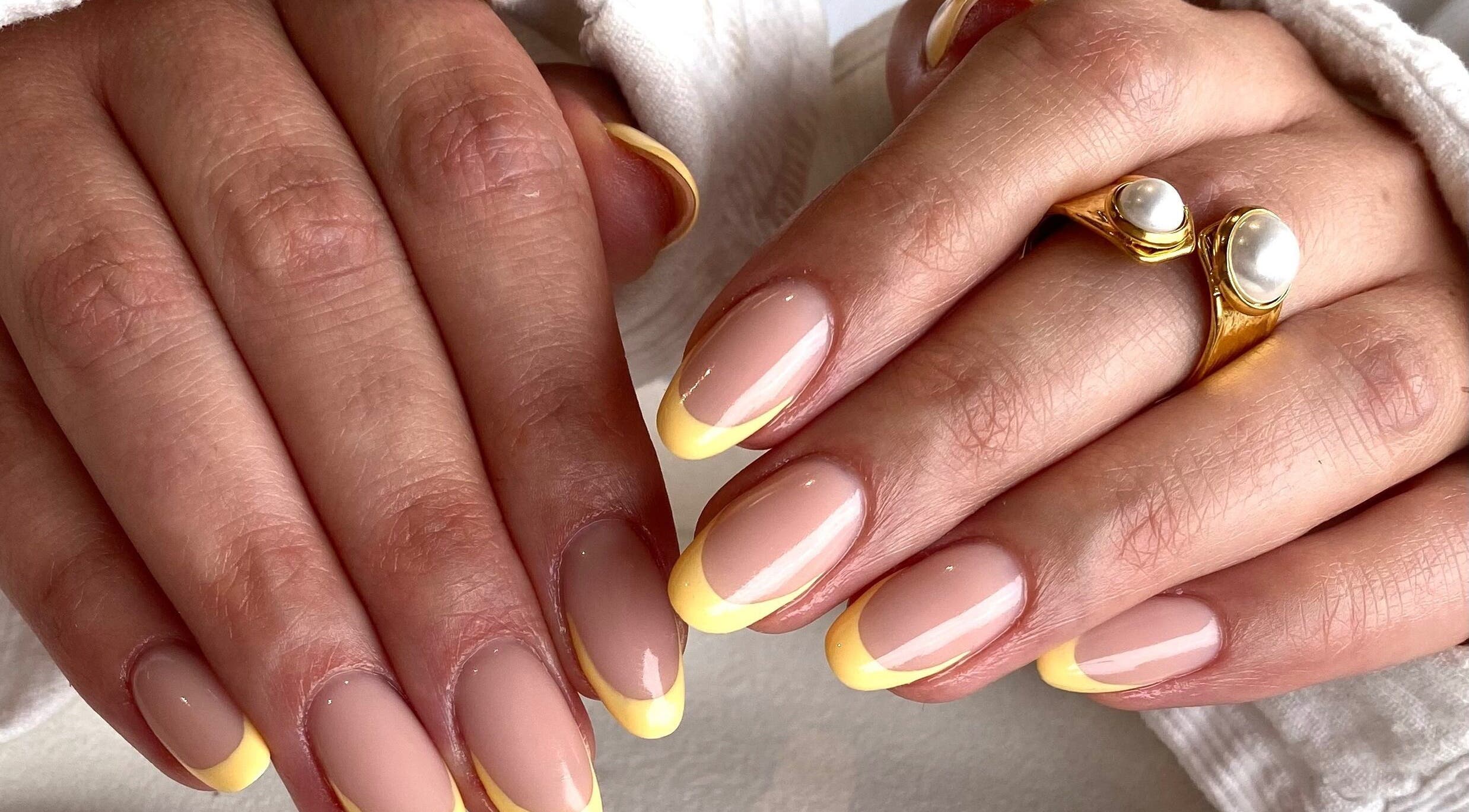 Yellow-tipped manicure at Suzi Q Nails, Melbourne, Victoria, AU showing elegant nail design.