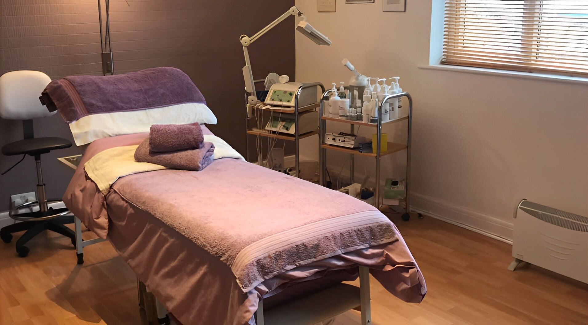 Cozy treatment room at Prestige Beauty Ltd, Birmingham, England, GB, with spa bed and beauty products.