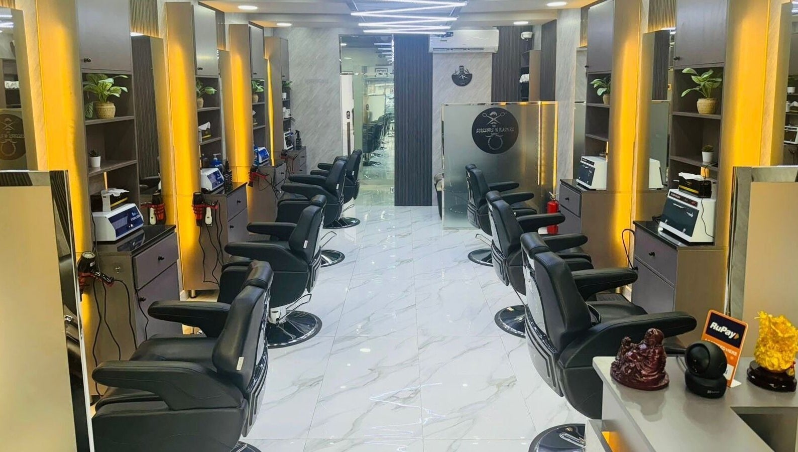 Modern interior of The Scissors N Razors Saloon in Abu Dhabi, Abu Dhabi, AE, featuring sleek styling chairs.