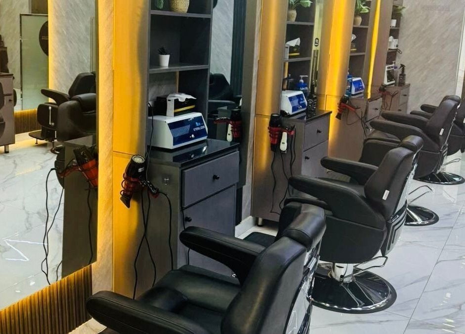 Modern interior at The Scissors N Razors Saloon, Abu Dhabi, with sleek styling chairs and mirrors.