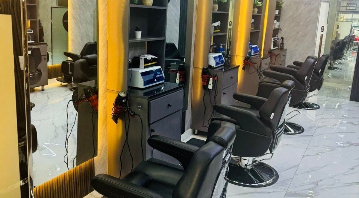 Modern interior at The Scissors N Razors Saloon, Abu Dhabi, with sleek styling chairs and mirrors.