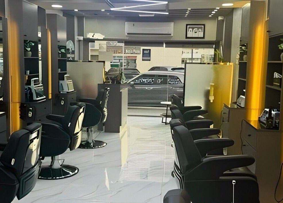 Sleek salon interior at The Scissors N Razors Saloon, Abu Dhabi, AE, featuring modern styling stations.