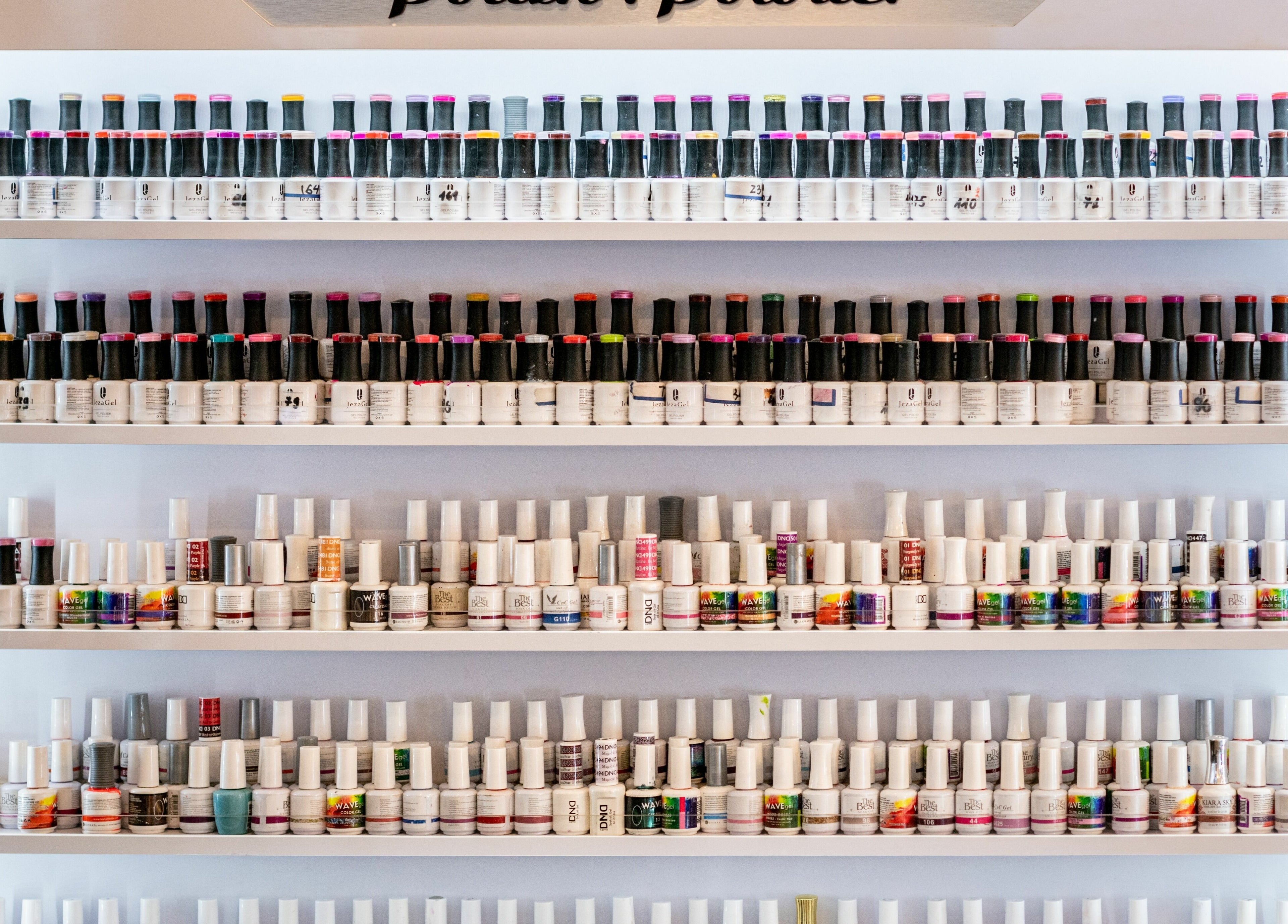 Diverse nail polish collection at Nj Image Nails, Toms River, New Jersey, US, showcasing vibrant colors.