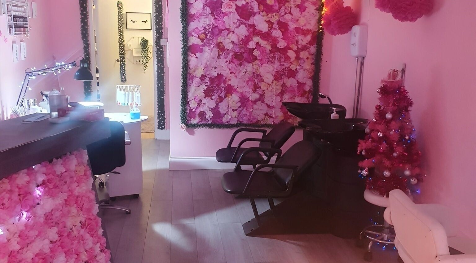 Chic pink interior of A Million Dreams Hair and Beauty in Whitley Bay, England, GB featuring floral decor.