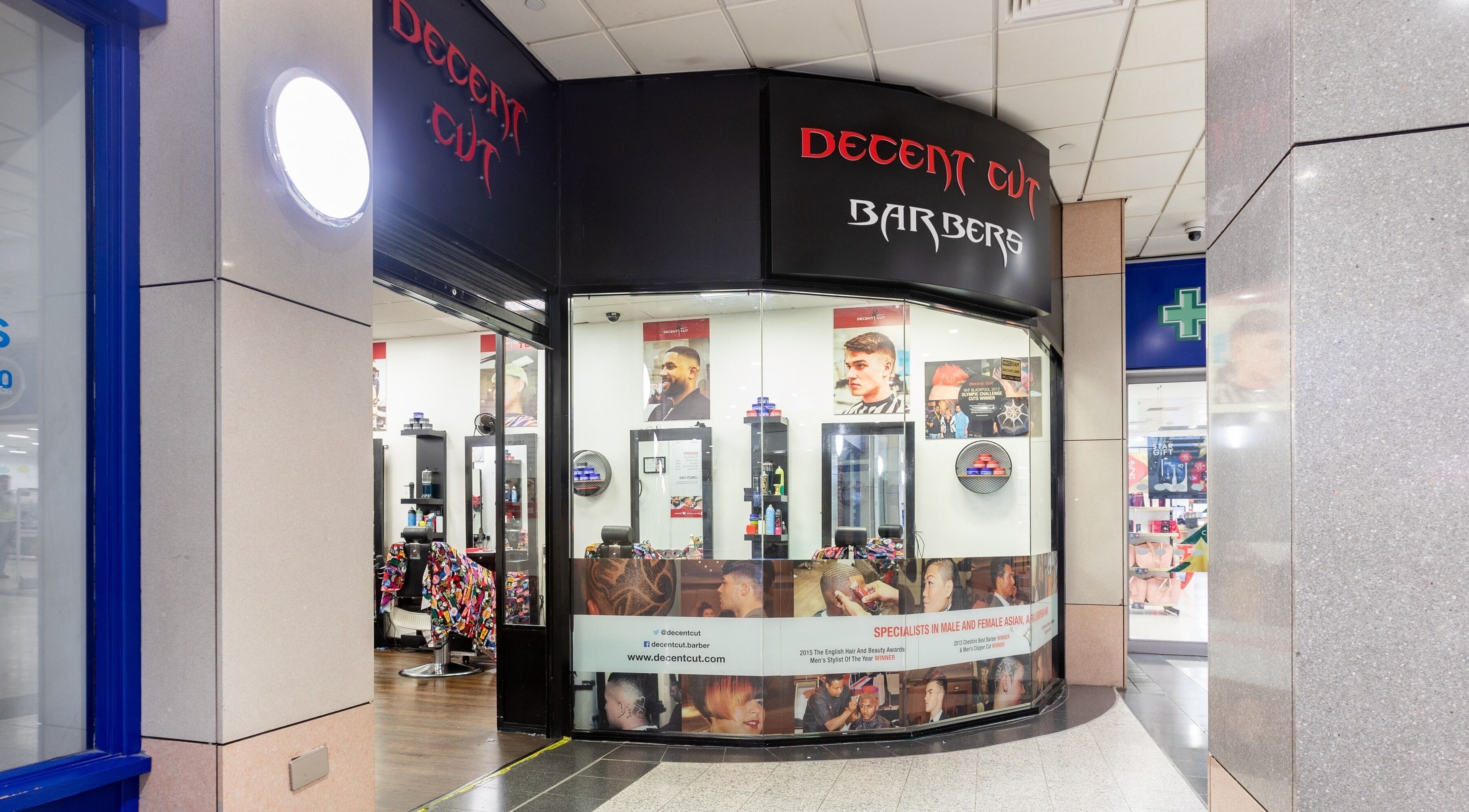 Exterior of Decent Cut barbershop in Manchester, England, GB showcasing modern styling services.