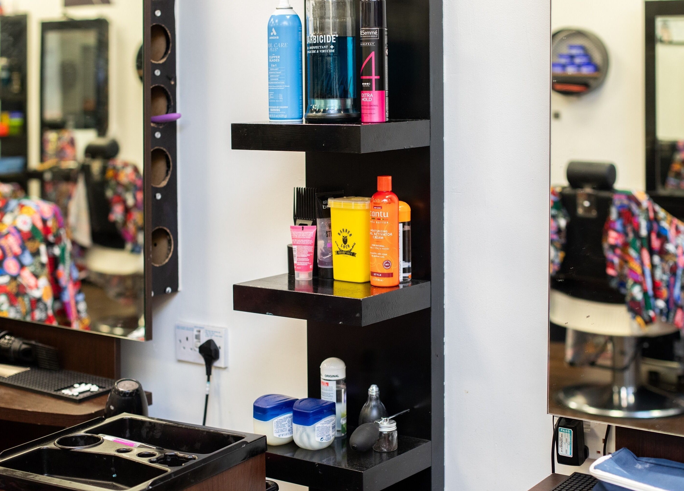 Modern salon shelves at Decent Cut, Manchester, England, GB, neatly display haircare products.