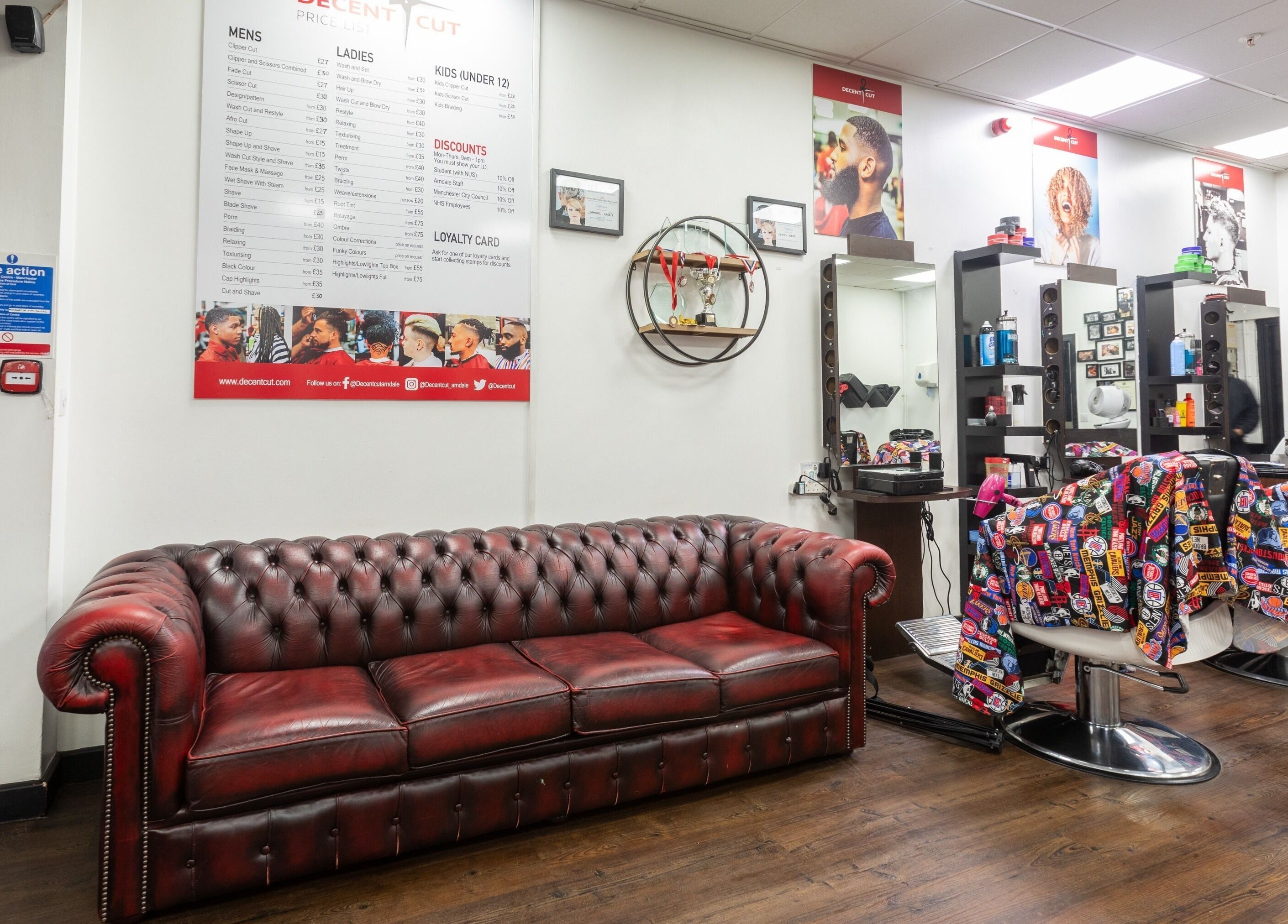 Decent Cut salon interior with red leather couch in Manchester, England, GB.