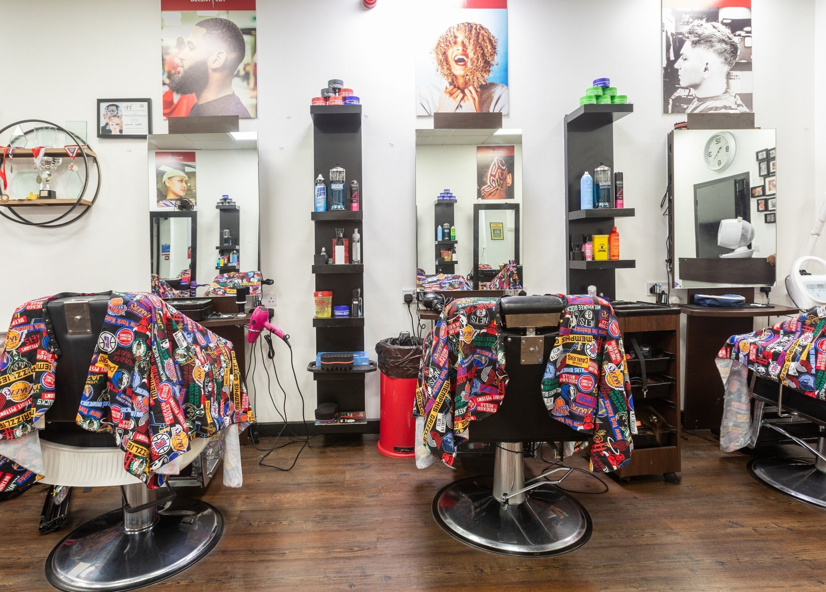Interior view of Decent Cut salon in Manchester, England, GB featuring colorful barber chairs and modern decor.