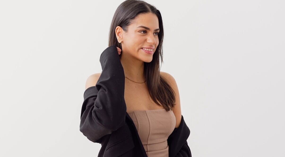 Smiling woman with stylish attire at Little Lash Lab, Melbourne, Victoria, AU.