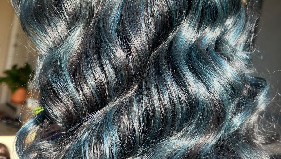 Shiny, dark blue curls styled at Costyle Hairdresser Salon in Morley, Western Australia, AU highlight vibrant elegance.