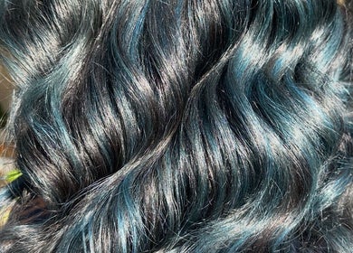 Shiny, dark blue curls styled at Costyle Hairdresser Salon in Morley, Western Australia, AU highlight vibrant elegance.