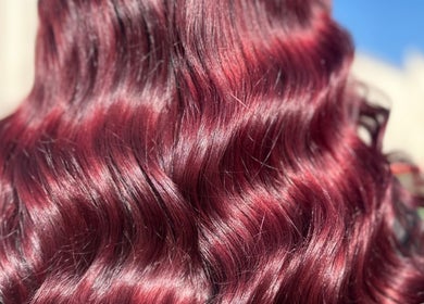 Vibrant crimson wavy hair styled at Costyle Hairdresser Salon in Morley, Western Australia, AU.