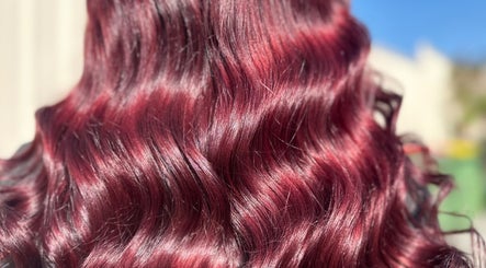 Vibrant crimson wavy hair styled at Costyle Hairdresser Salon in Morley, Western Australia, AU.