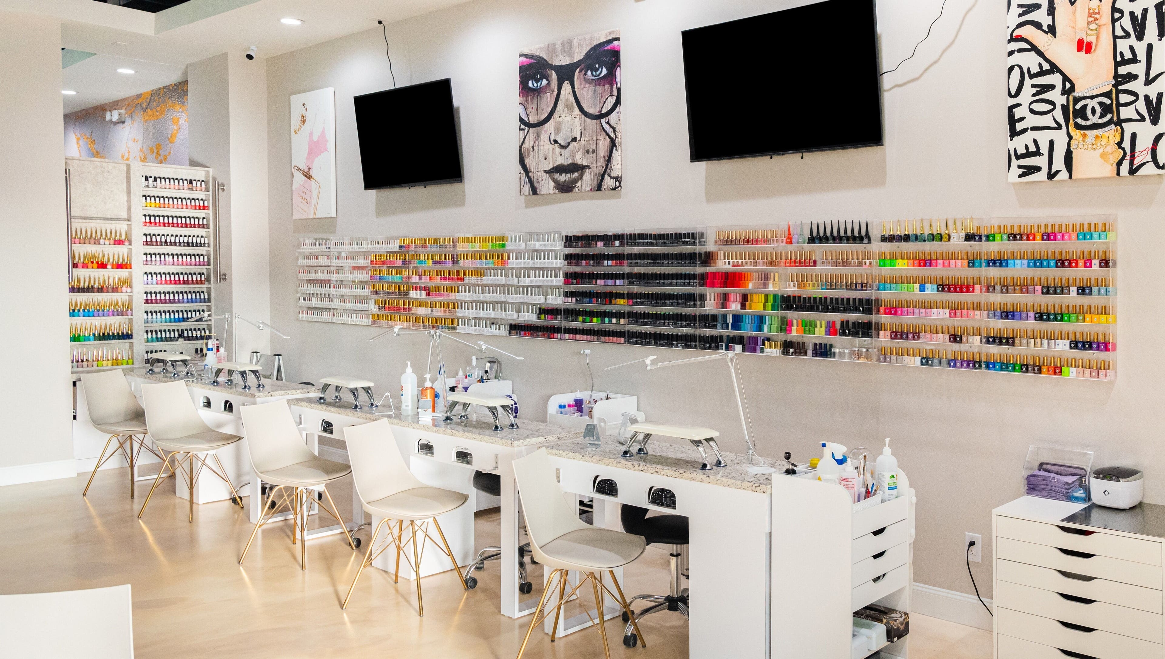Gloss Nail Atelier in Sterling Heights, Michigan showcases a vibrant nail polish wall and modern manicure stations.