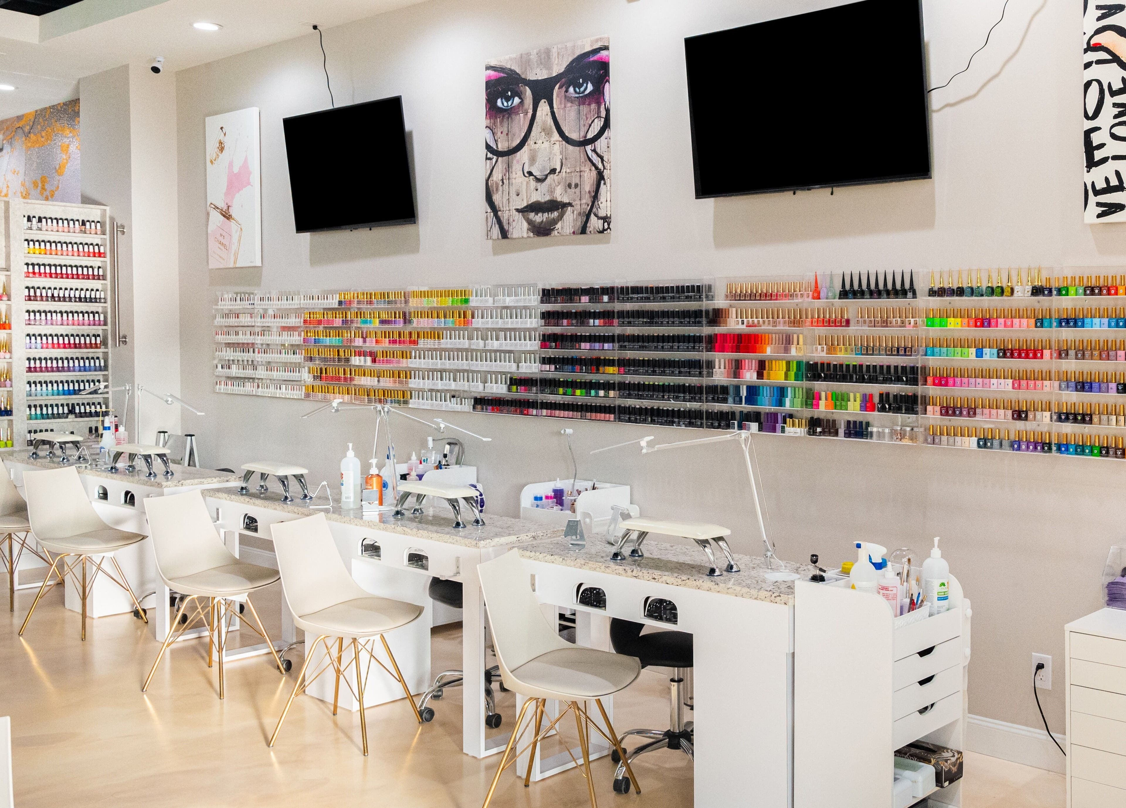 Gloss Nail Atelier in Sterling Heights, Michigan showcases a vibrant nail polish wall and modern manicure stations.