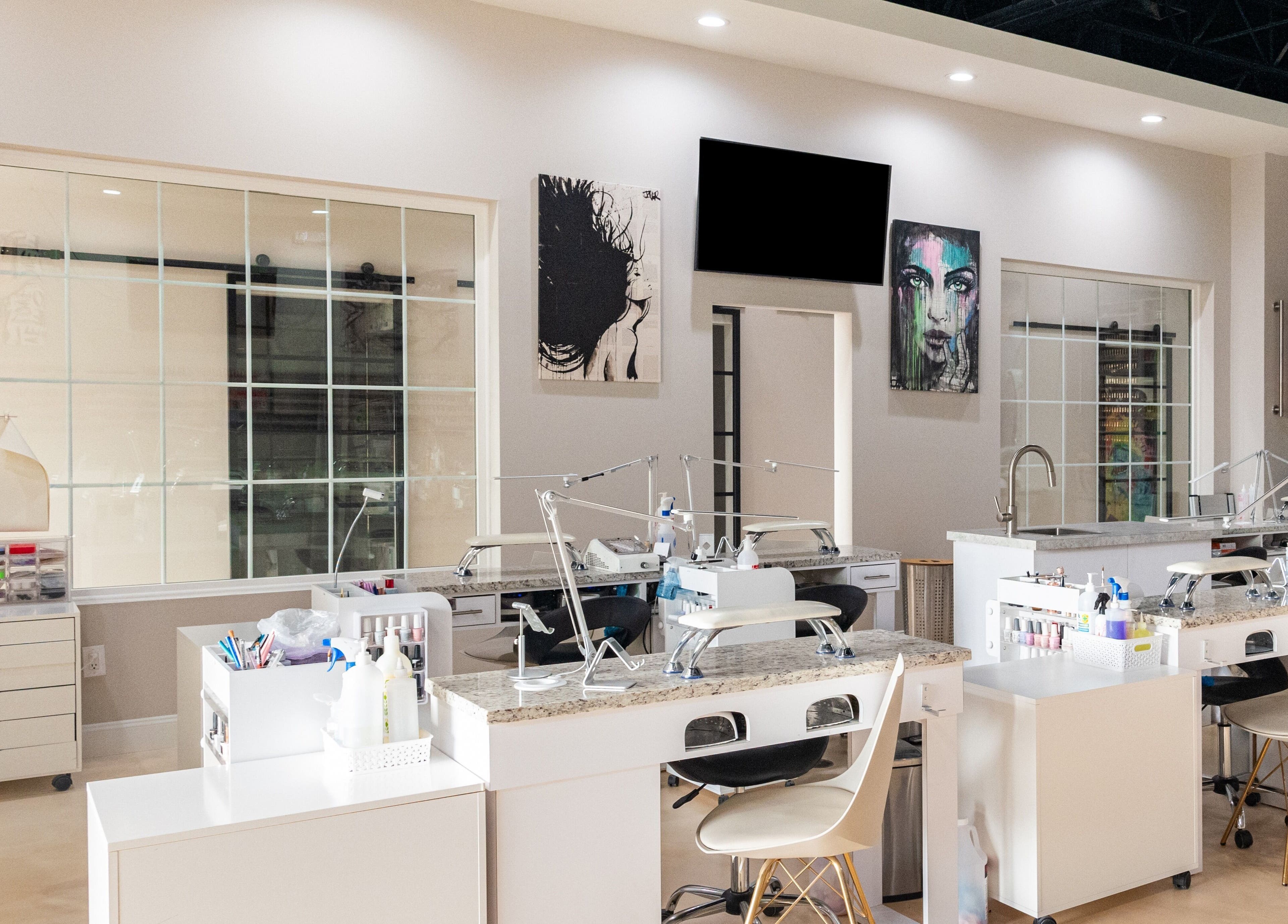 Modern interior of Gloss Nail Atelier in Sterling Heights, Michigan, US featuring sleek nail stations and chic decor.