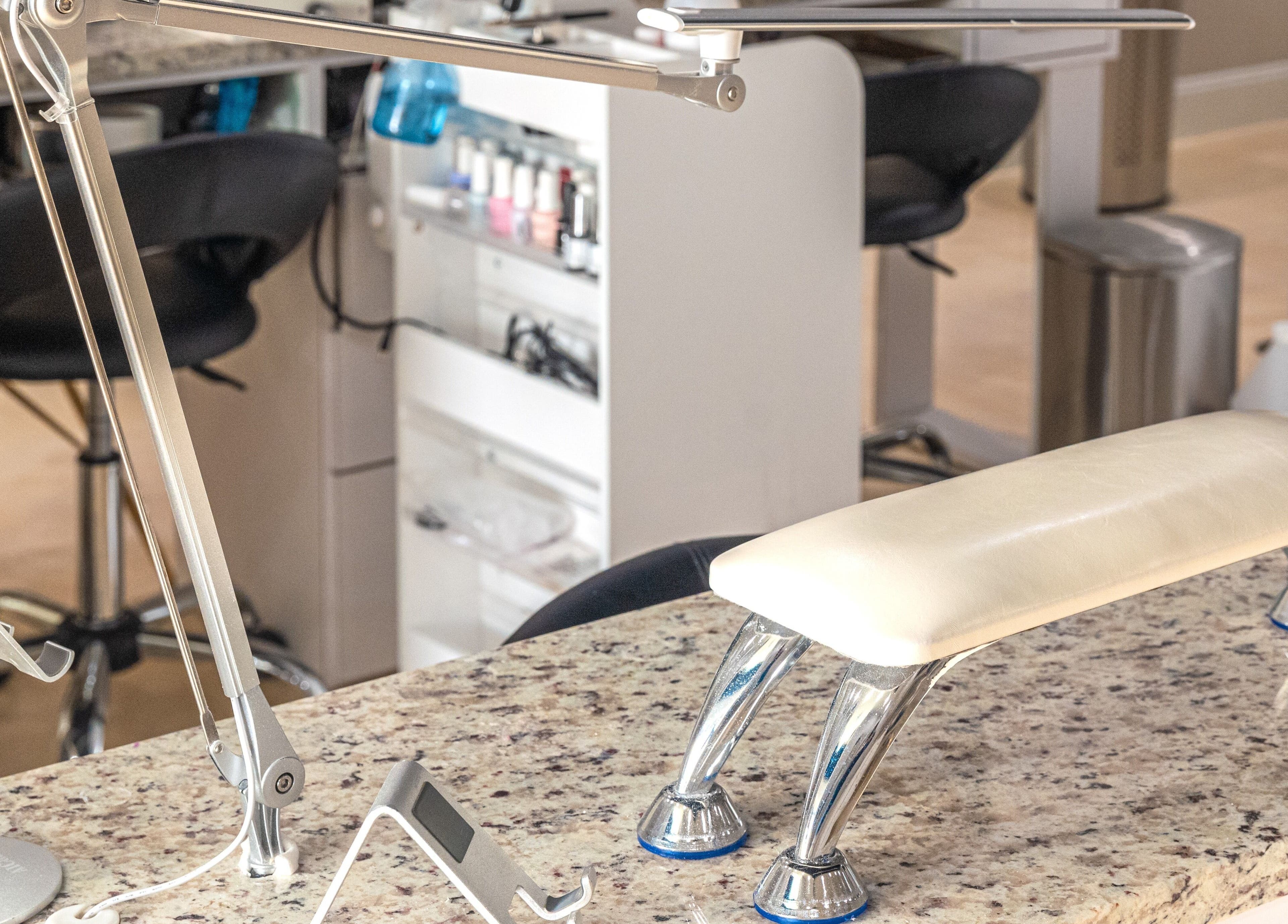 Modern nail station setup at Gloss Nail Atelier, Sterling Heights, Michigan, US, featuring chic furnishings.