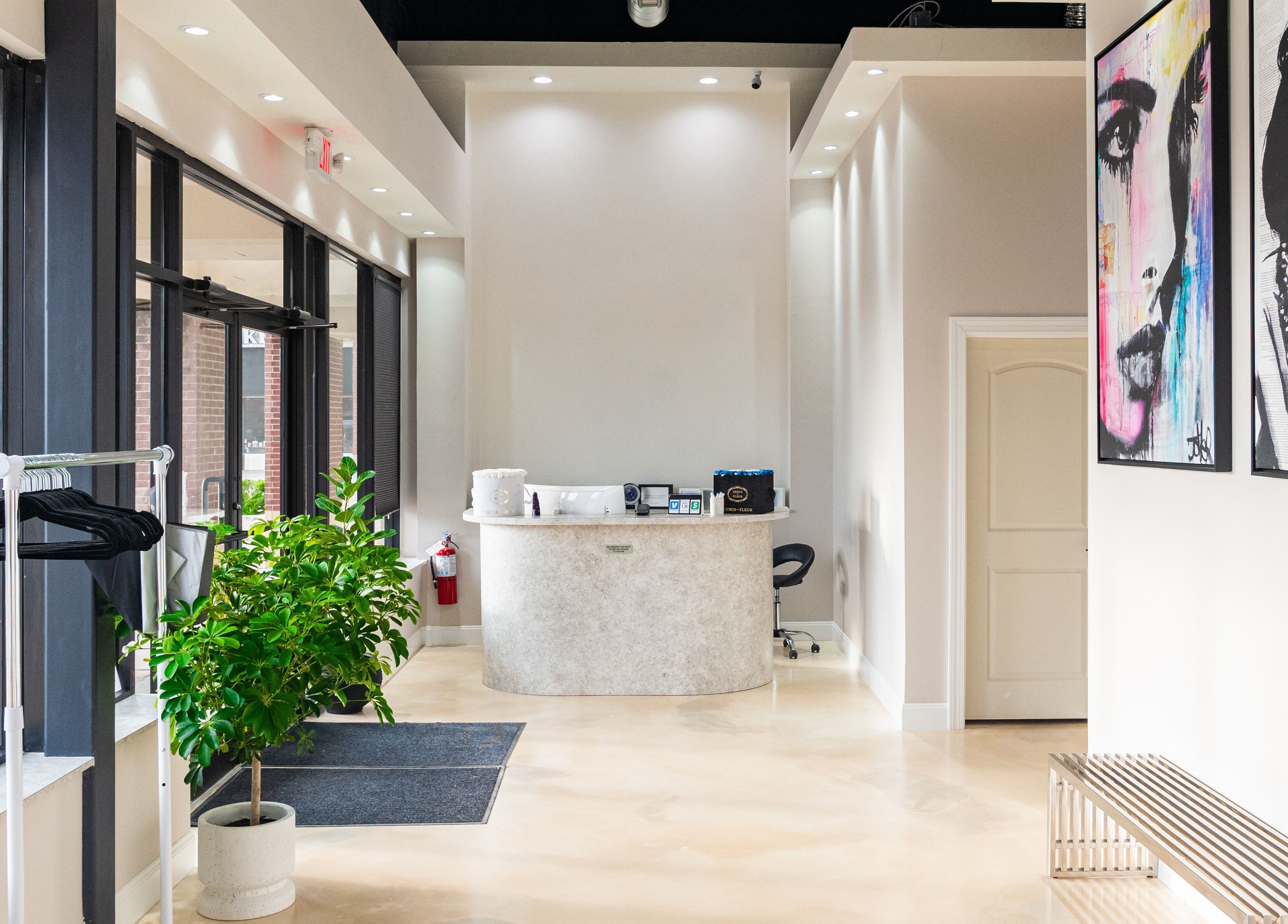 Bright, modern entrance at Gloss Nail Atelier in Sterling Heights, Michigan, US with stylish decor and vivid art.