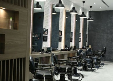 Chic interior of Hair Fusion Gents Saloon Wadi Al Safa 3 Branch, دبي, دبي, AE, showcasing modern styling chairs.