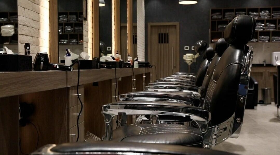 Chic interior of Hair Fusion Gents Salon Mirdif in Dubai, AE with sleek black chairs and modern design.