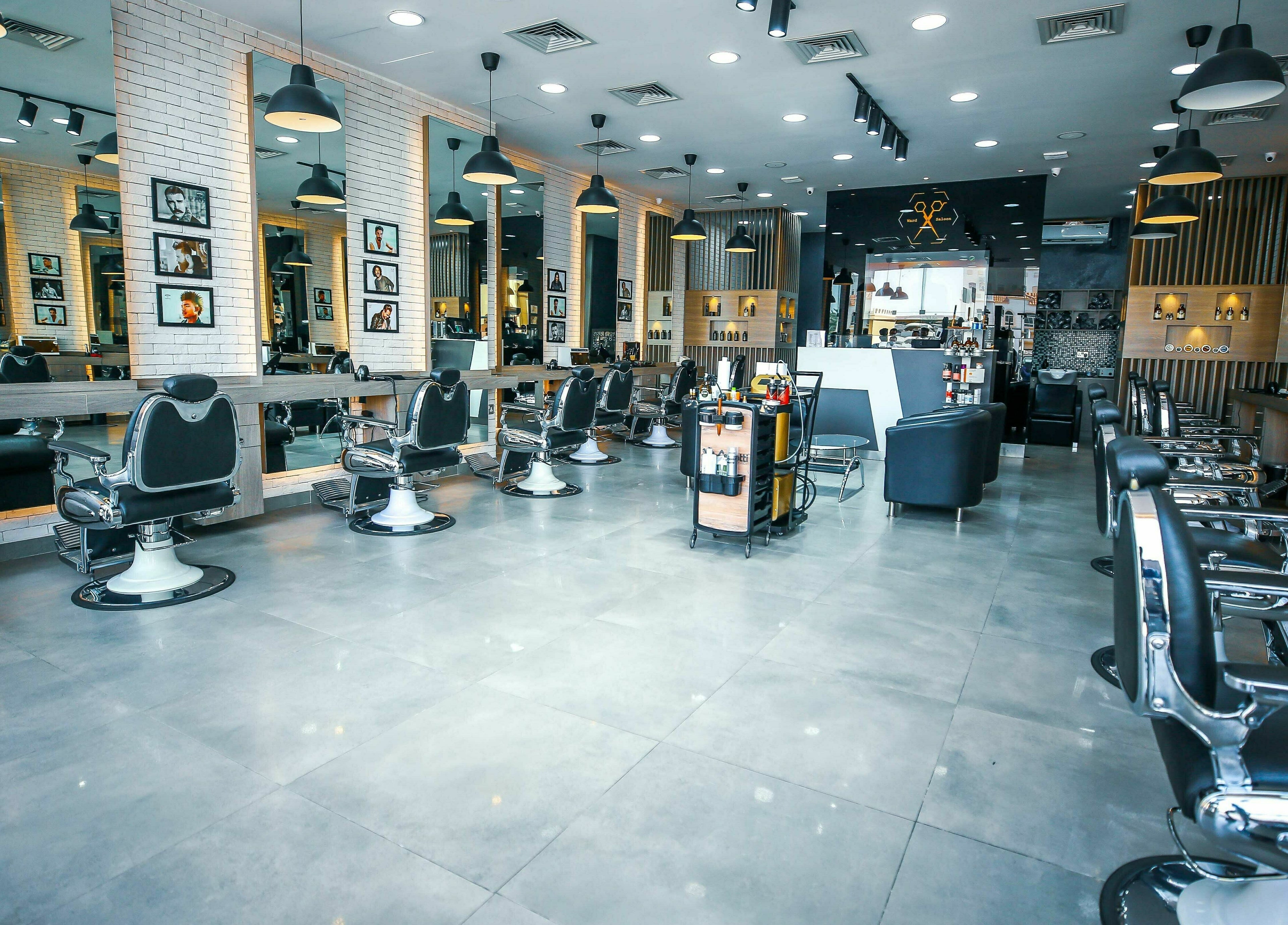 Spacious, modern interior of Ward Salon in Dubai, Dubai, AE with stylish black chairs and illuminated mirrors.