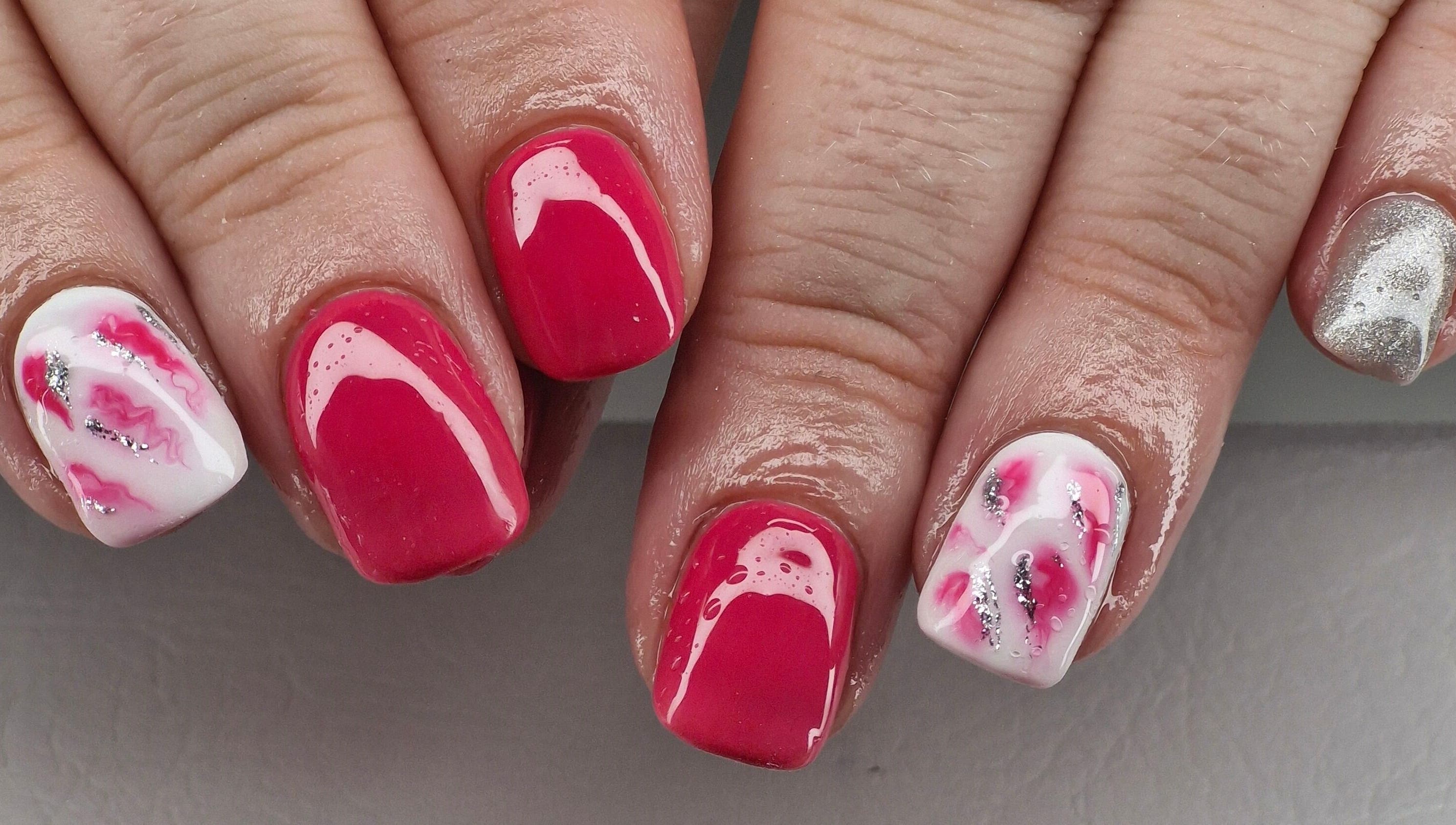 Vibrant nail art at Beauty By Jo, Guiseley, England. Showcasing pink, silver, and white designs.