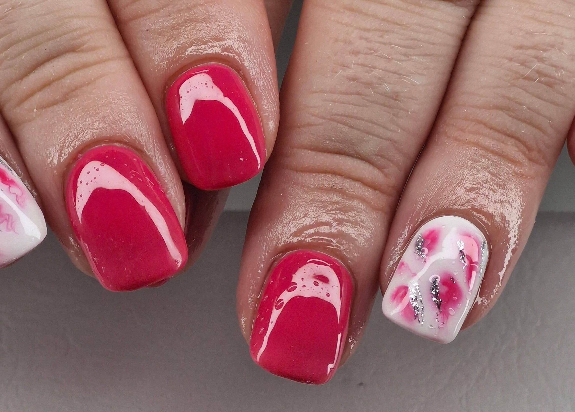 Vibrant nail art at Beauty By Jo, Guiseley, England. Showcasing pink, silver, and white designs.
