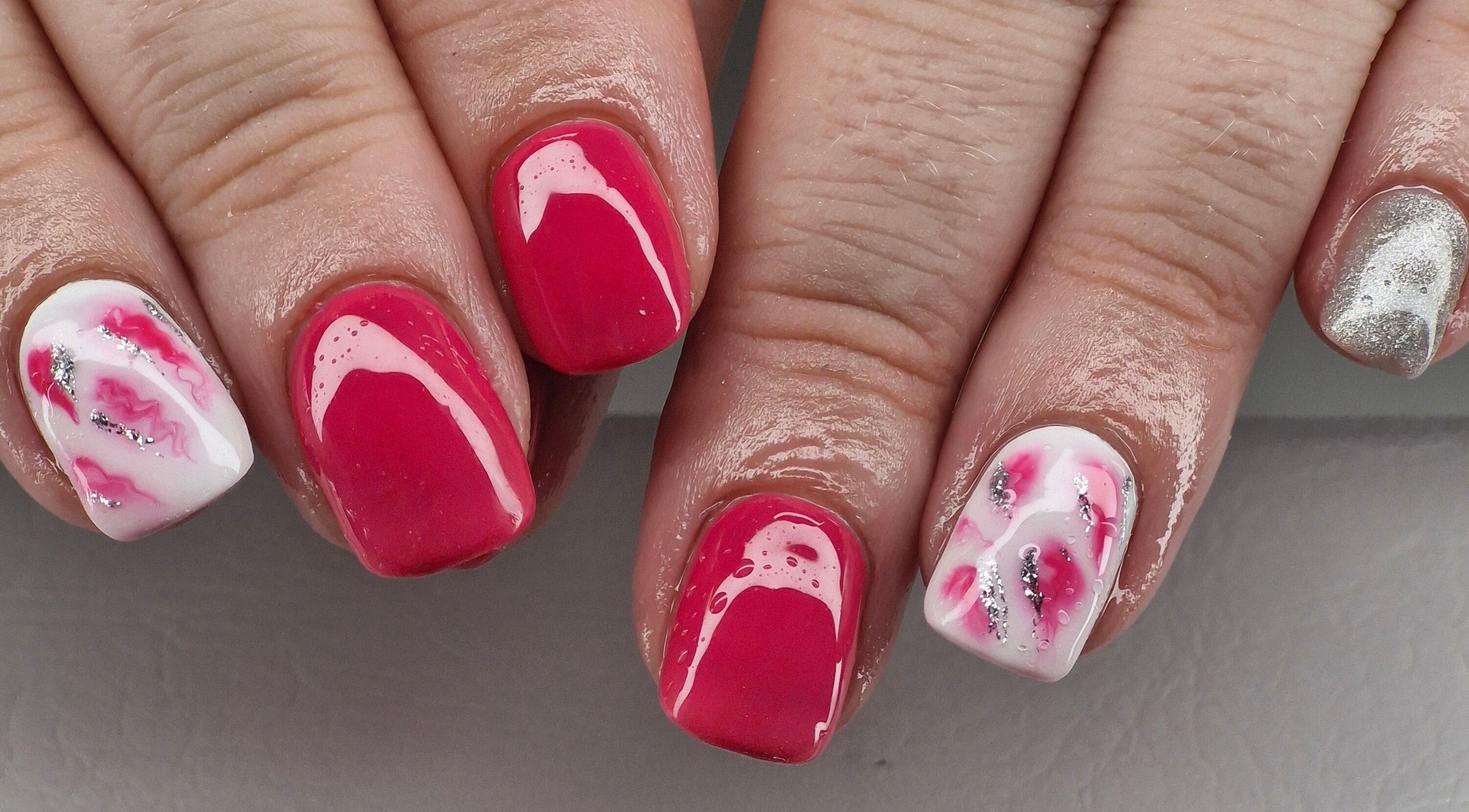 Vibrant nail art at Beauty By Jo, Guiseley, England. Showcasing pink, silver, and white designs.