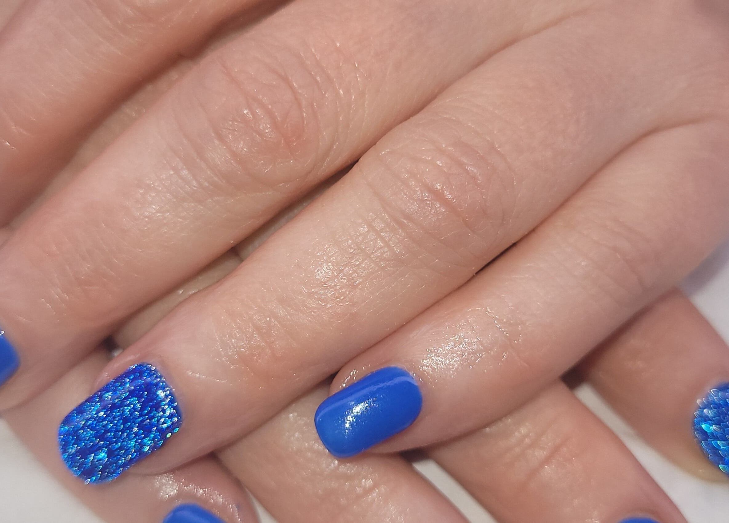 Stylish blue manicure at Beauty By Jo in Guiseley, England, GB, showcasing vibrant, textured nail art.