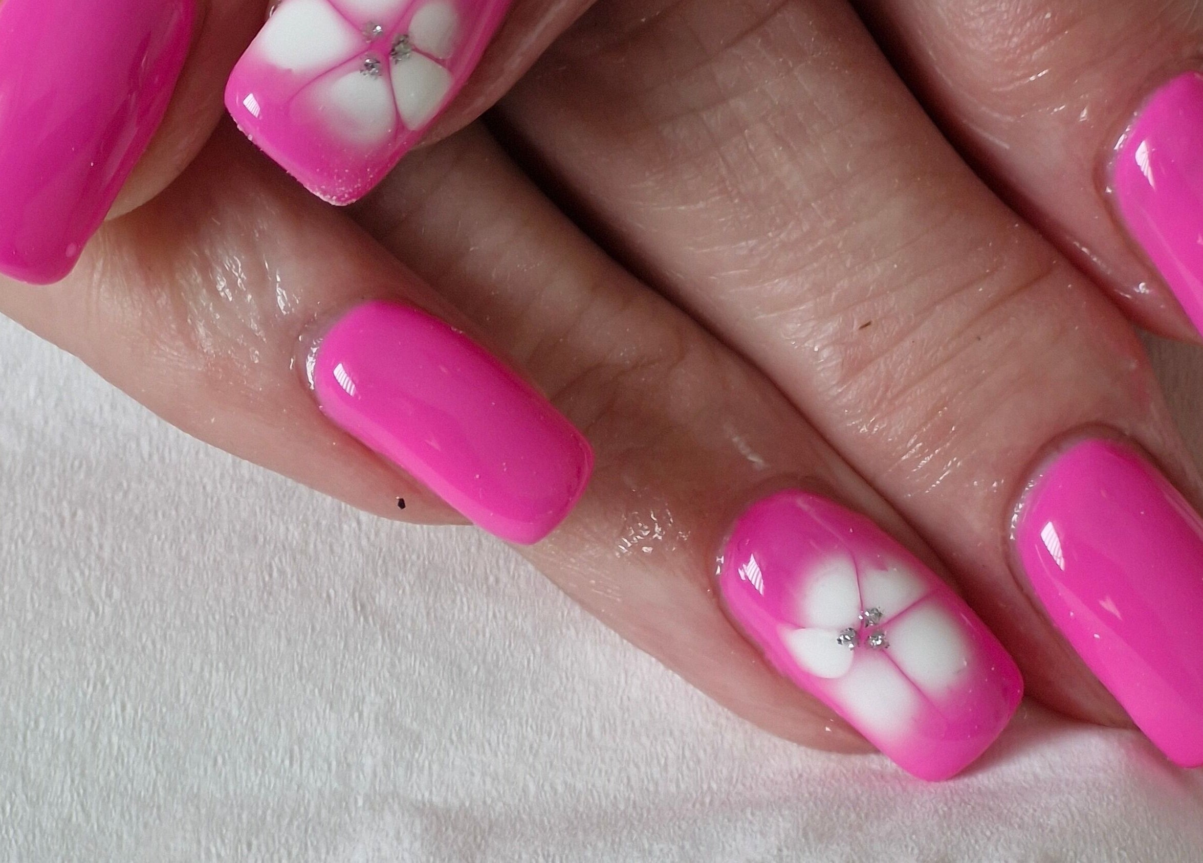 Bright pink floral nail art at Beauty By Jo in Guiseley, England, GB, showcasing stylish manicure.