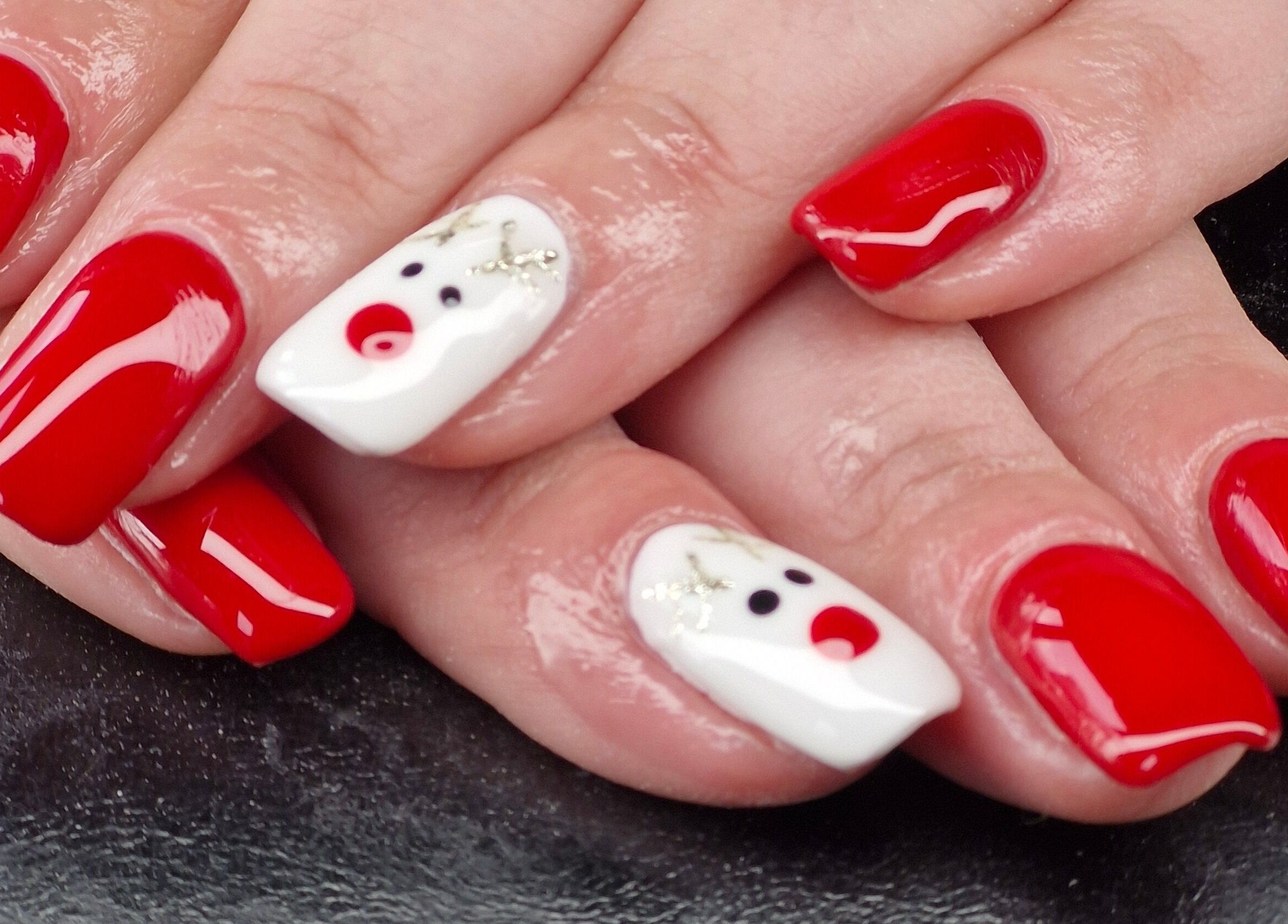 Festive red and white nail art at Beauty By Jo, Guiseley, England, GB offers a holiday-ready manicure.