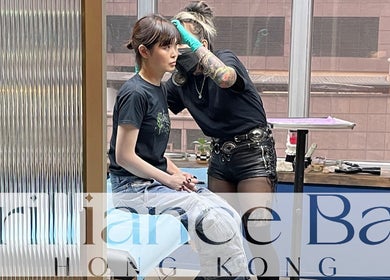 Piercing expert at Brilliance Bay Piercing Boutique, Central, Hong Kong Island, HK, ensuring precision for a client.