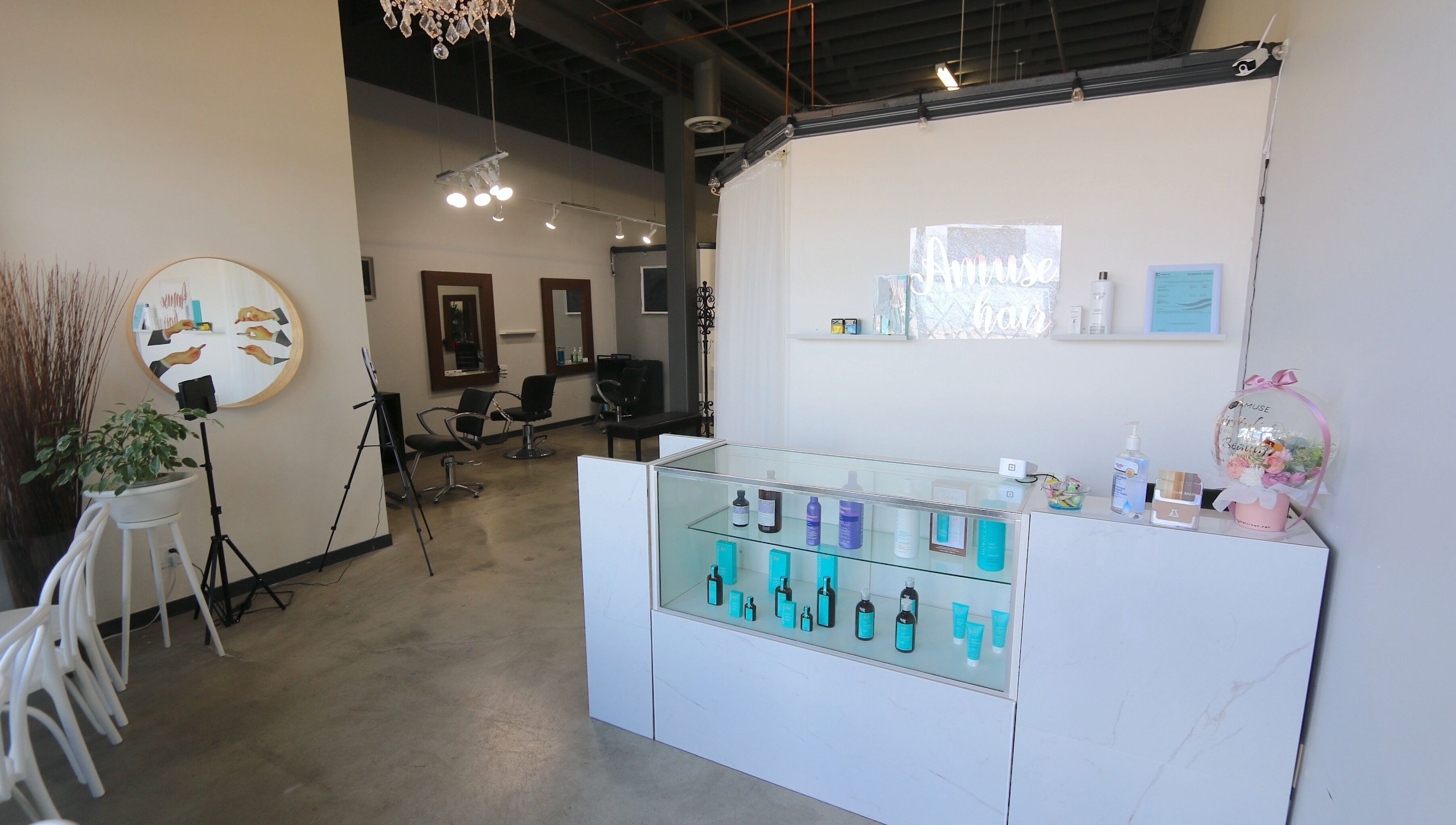 Amuse Hair and Nail Salon's chic interior in Langley City, British Columbia, CA features stylish chairs and products.